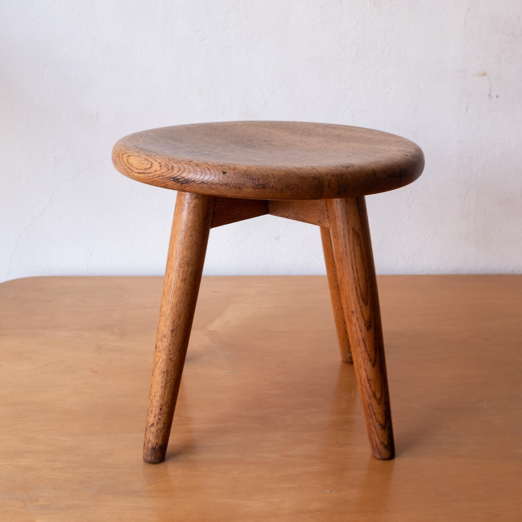 Modernist handcrafted Berger-style stool. Slightly concaved top.  Great architectural structure in solid oak with a wonderful patina. Retains an inventory tag from the City-County of San Francisco. 1950s.