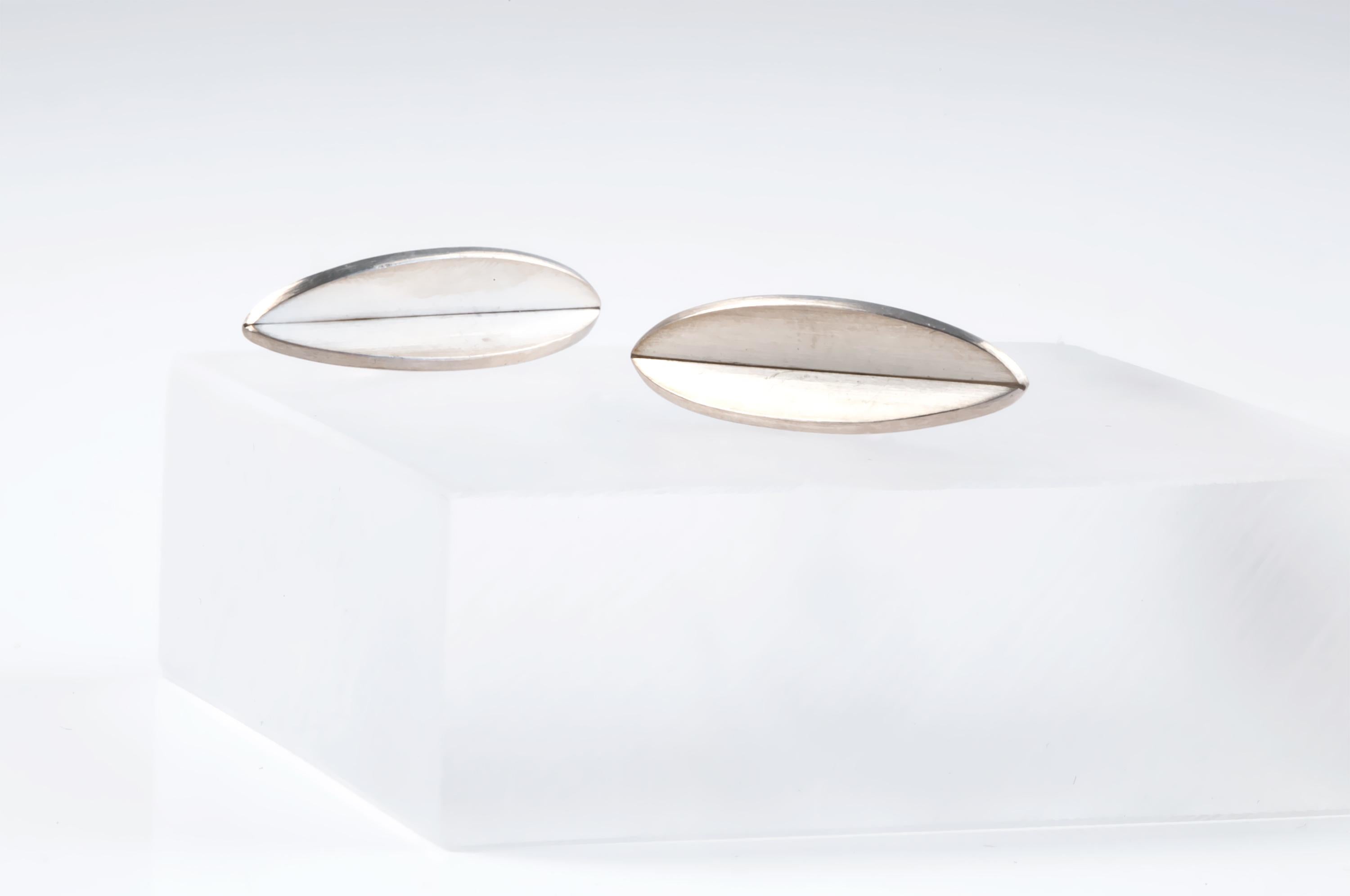 Minimalist, subtle and organic silver stud earrings in the shape of a seed. Designed and custom made in 2015, by silversmith Heidi Sand. Both earrings are in excellent condition. 