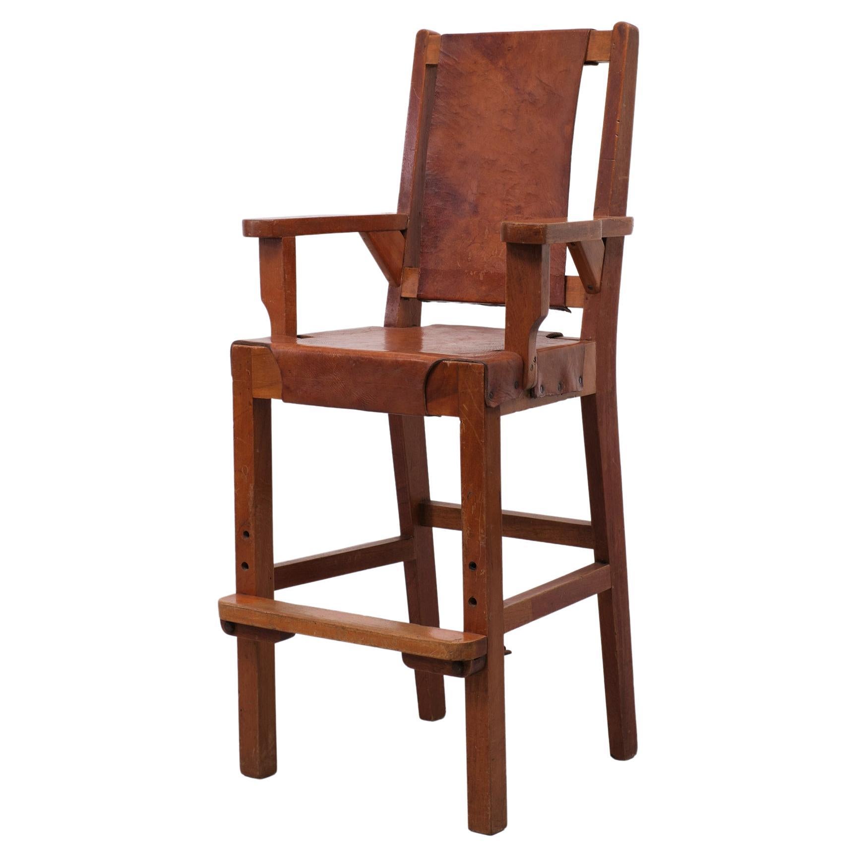 Unique handmade High chair, wooden frame, comes with Saddle Leather upholstery. In a Cognac color. Aadjustable feet rest Great looking piece. Gerrit Rietveld in style.