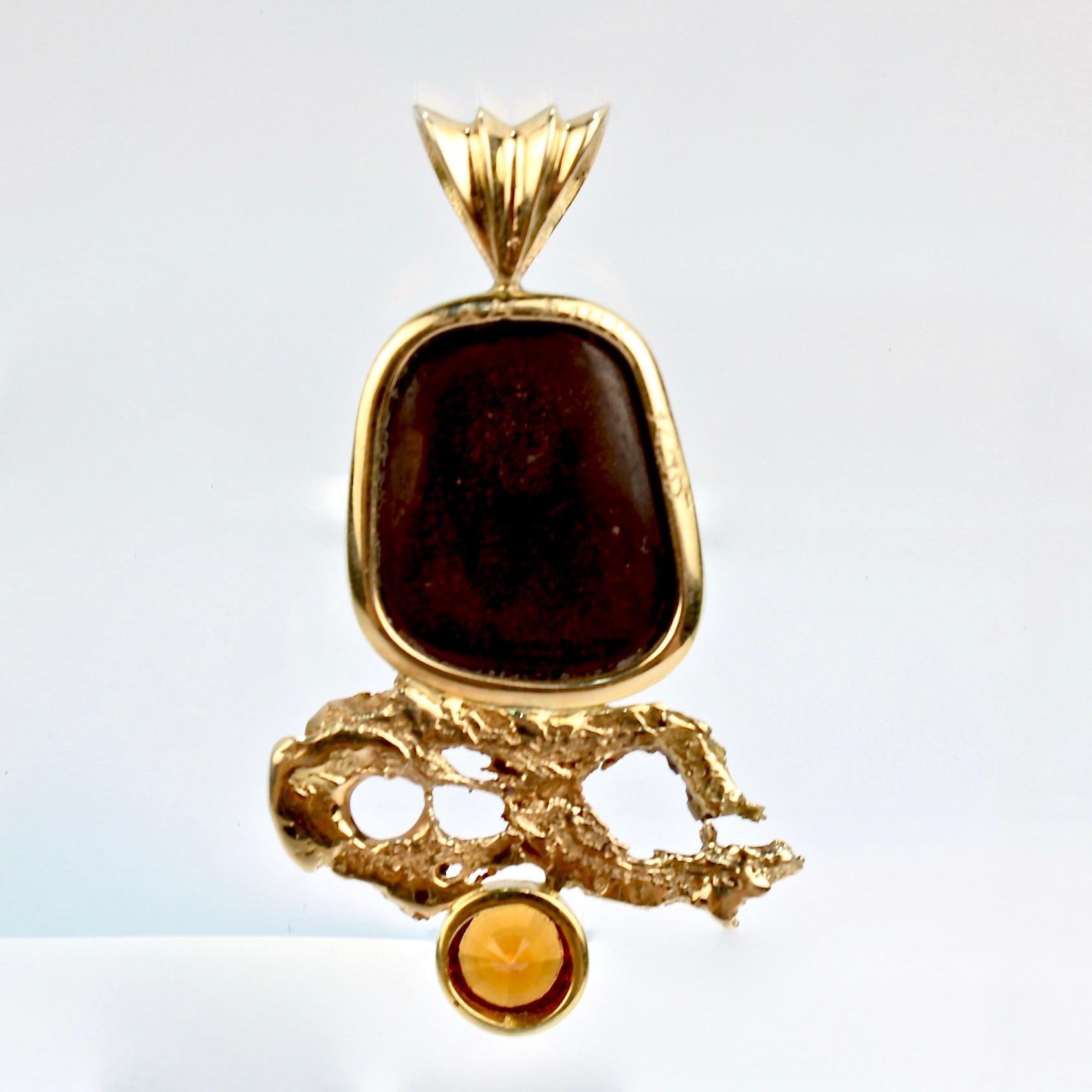 A very fine organic modernist pendant.

With a large bezel set opal and a round-cut Madeira citrine in 14 karat and 22 karat gold.

This fire in this opal dazzles and is perfectly offset by the complimentary orange of the Madeira citrine. Simply