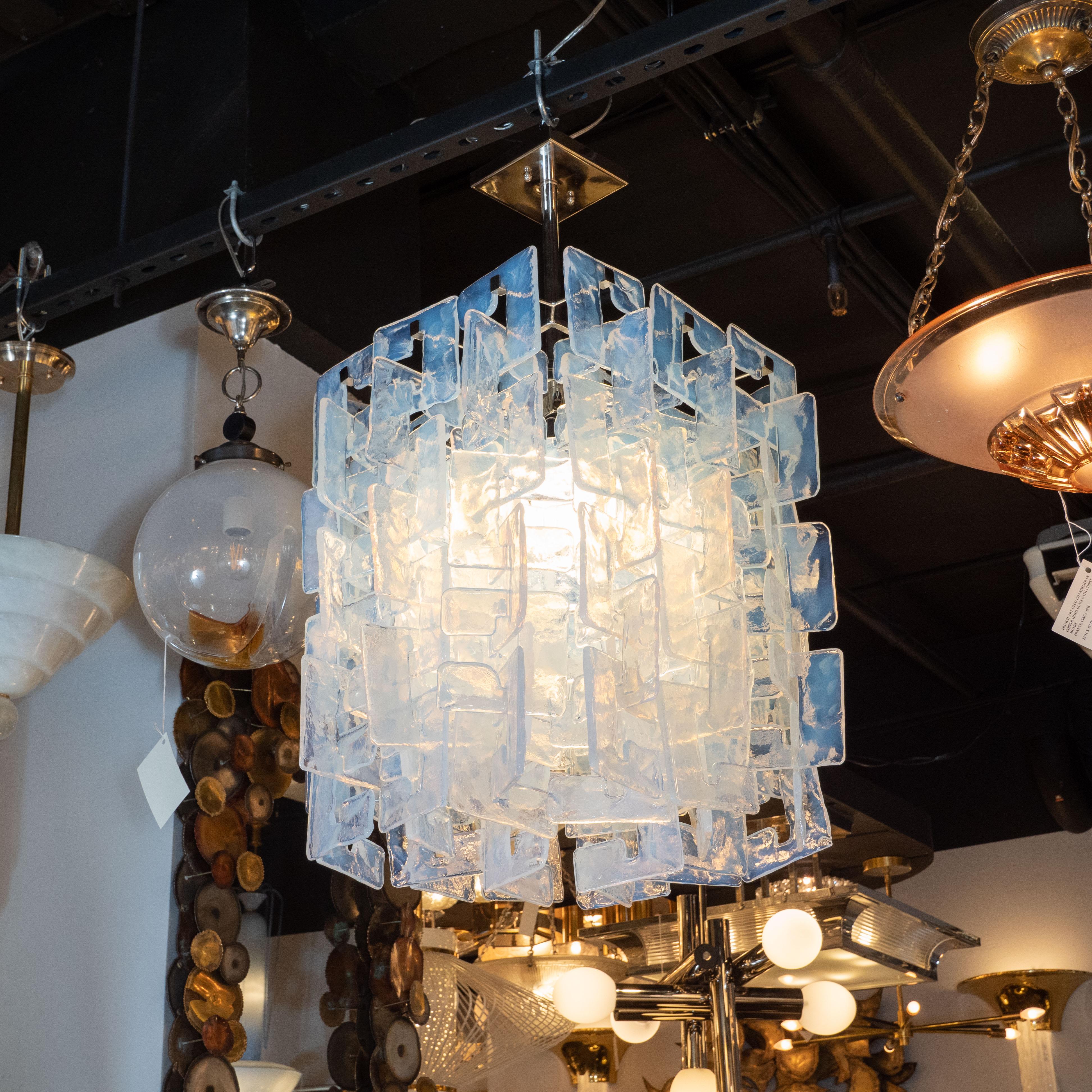 This stunning modernist chandelier was realized in Murano, Italy, the island off the coast of Venice renowned for centuries for its superlative glass production. It features rectangular bodies consisting of an abundance of translucent interlocking