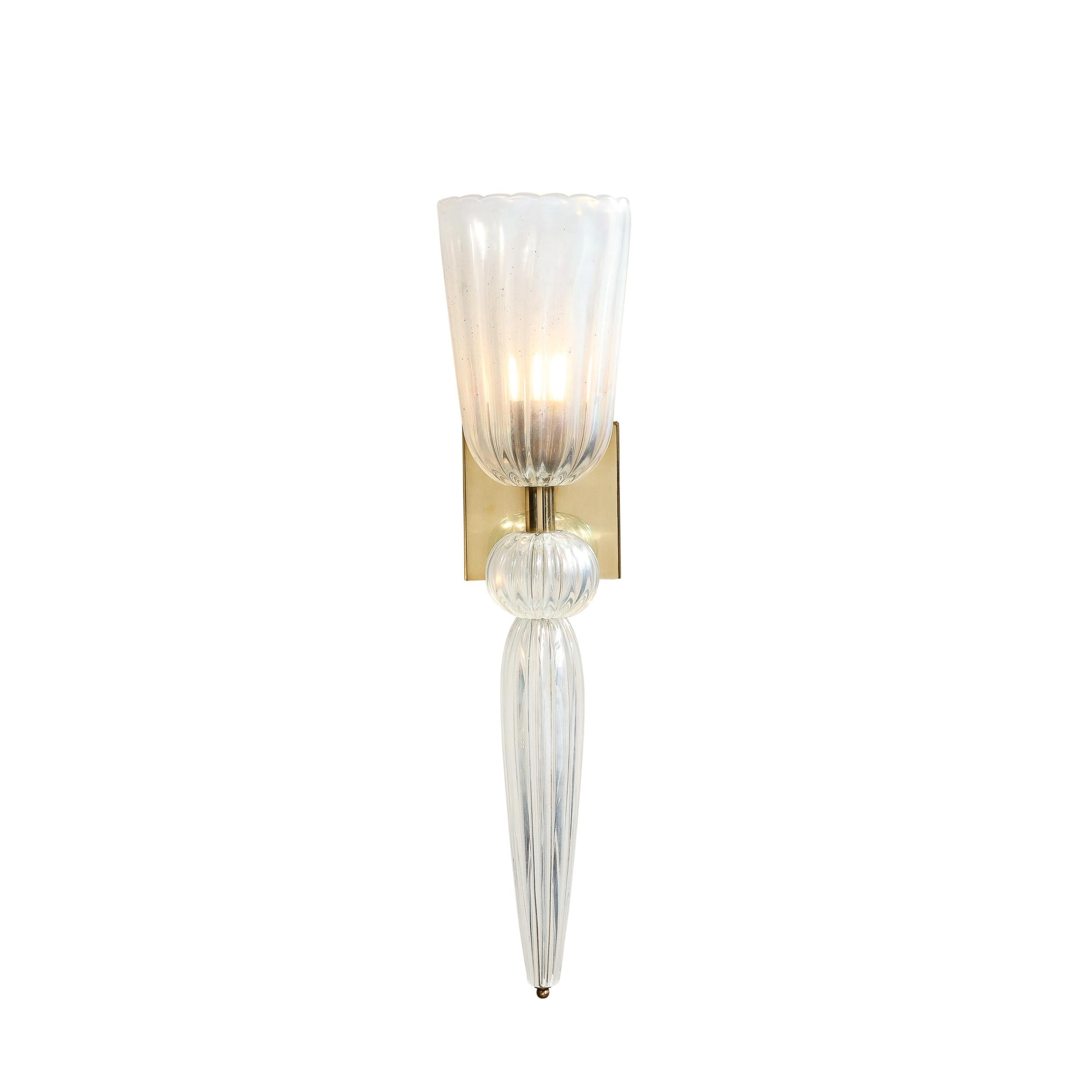 These dramatic and sculptural modernist sconces were hand blown in Murano, Italy- the island off the coast of Venice renowned for centuries for its superlative glass production. They feature elongated conical bodies capped with channeled elliptical