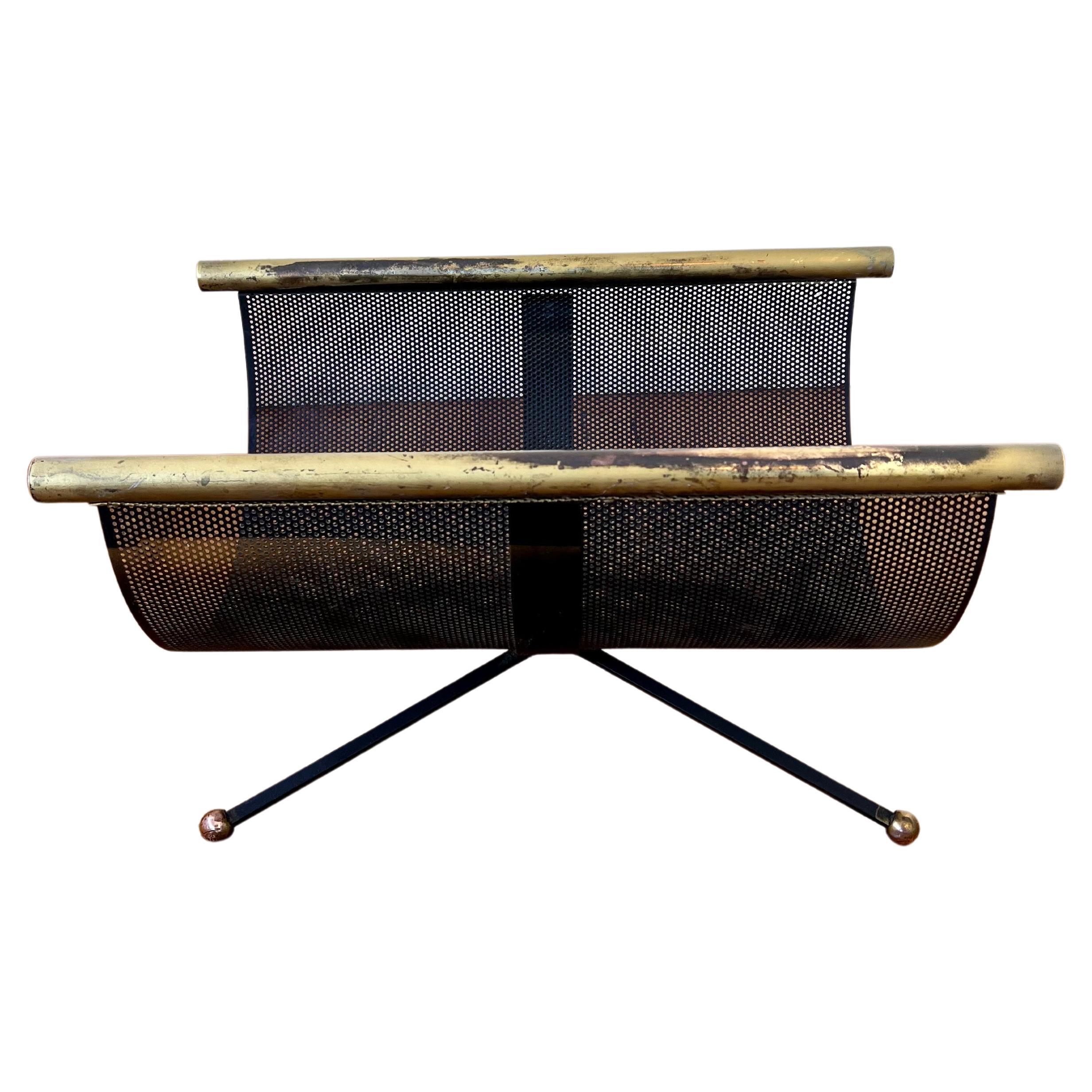 Midcentury Atomic age perforated metal, iron, and brass log holder, 1950s. Original patina and finish.
