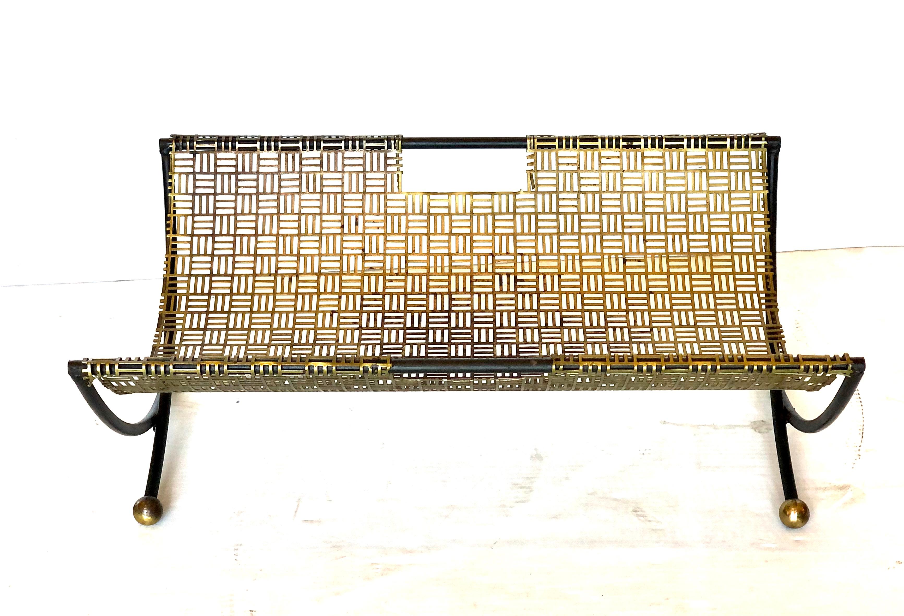 Midcentury perforated brass, iron and brass ball feet log holder, magazine rack, circa 1950s.