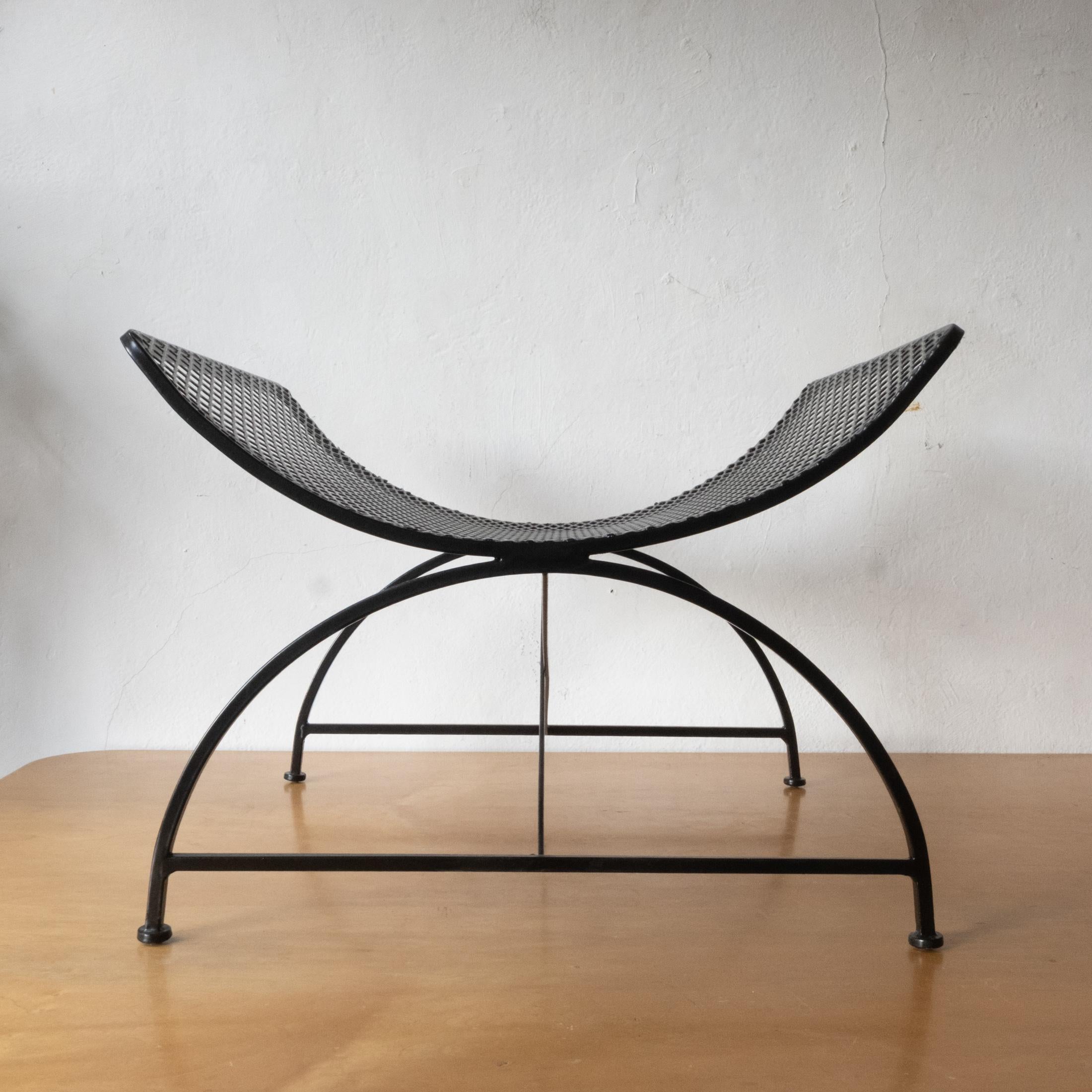 Arched iron and expanded metal catch all from the 1950s. Can be used inside or outside as a log holder, magazine stand, general catch all, or a poolside towel holder. Freshly powder coated to last another 50 plus years.