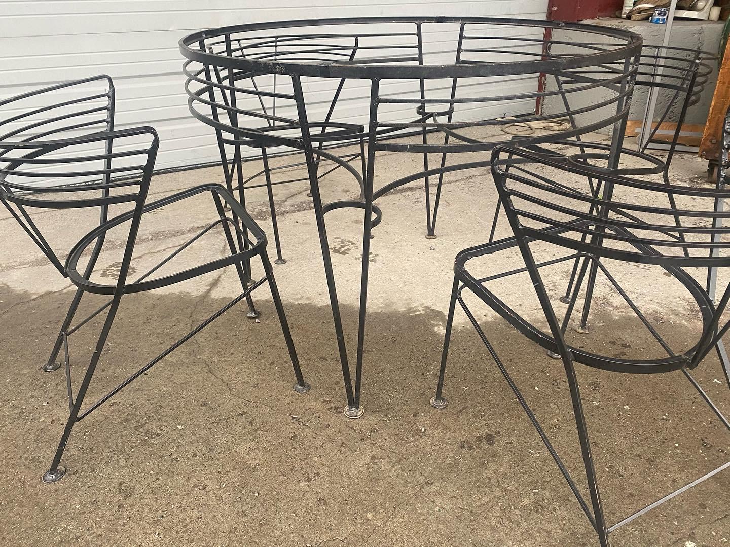 Modernist iron table and chairs attributed to John Salterini. Amazing design ! Superior quality and construction, Seat cushions newly upholstered, hand delivery avail to New York City or anywhere en route from Buffalo NY.