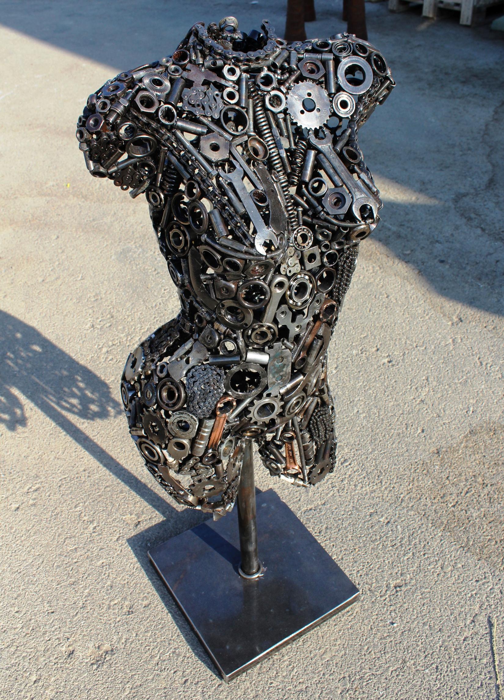 Modernist iron torso sculpture made up of mechanical parts.
 
 