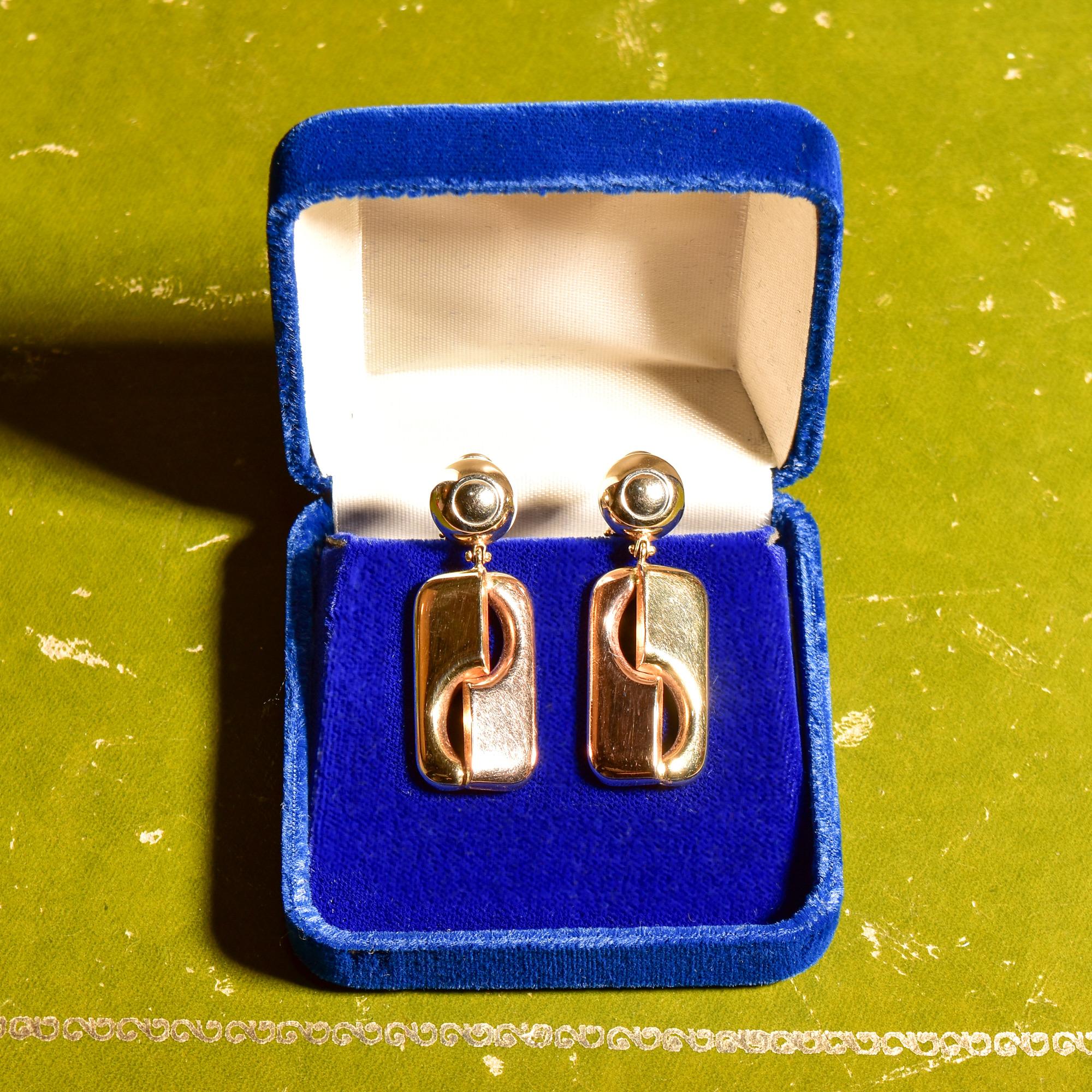 A fabulous pair of modernist Italian yellow gold drop dangle earrings with omega backs. Super stylish, versatile, and comfortable to wear. The earrings feature gold dome studs and a dangling puffed geometric ornament that looks like a rectangular