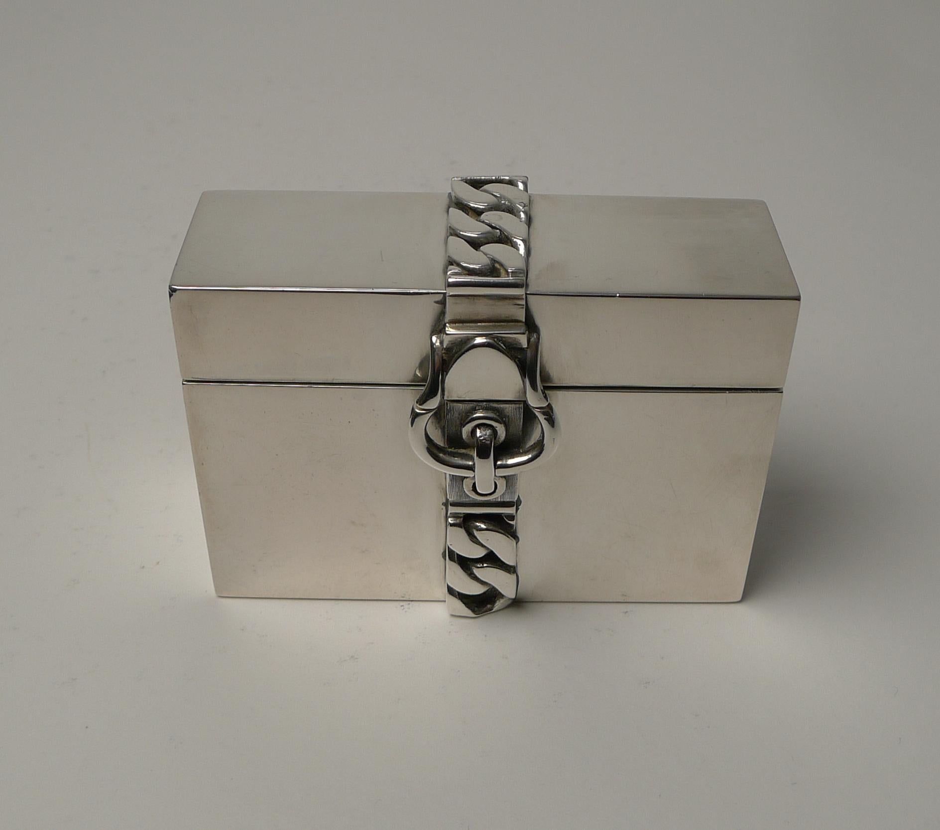 Hefty Italian silver was used to create this mid-century modern box with a stylish cast silver chain belt and buckle across the top and down the front, beautiful quality and engineering.

The lid when opened reveals a fitted interior accommodating