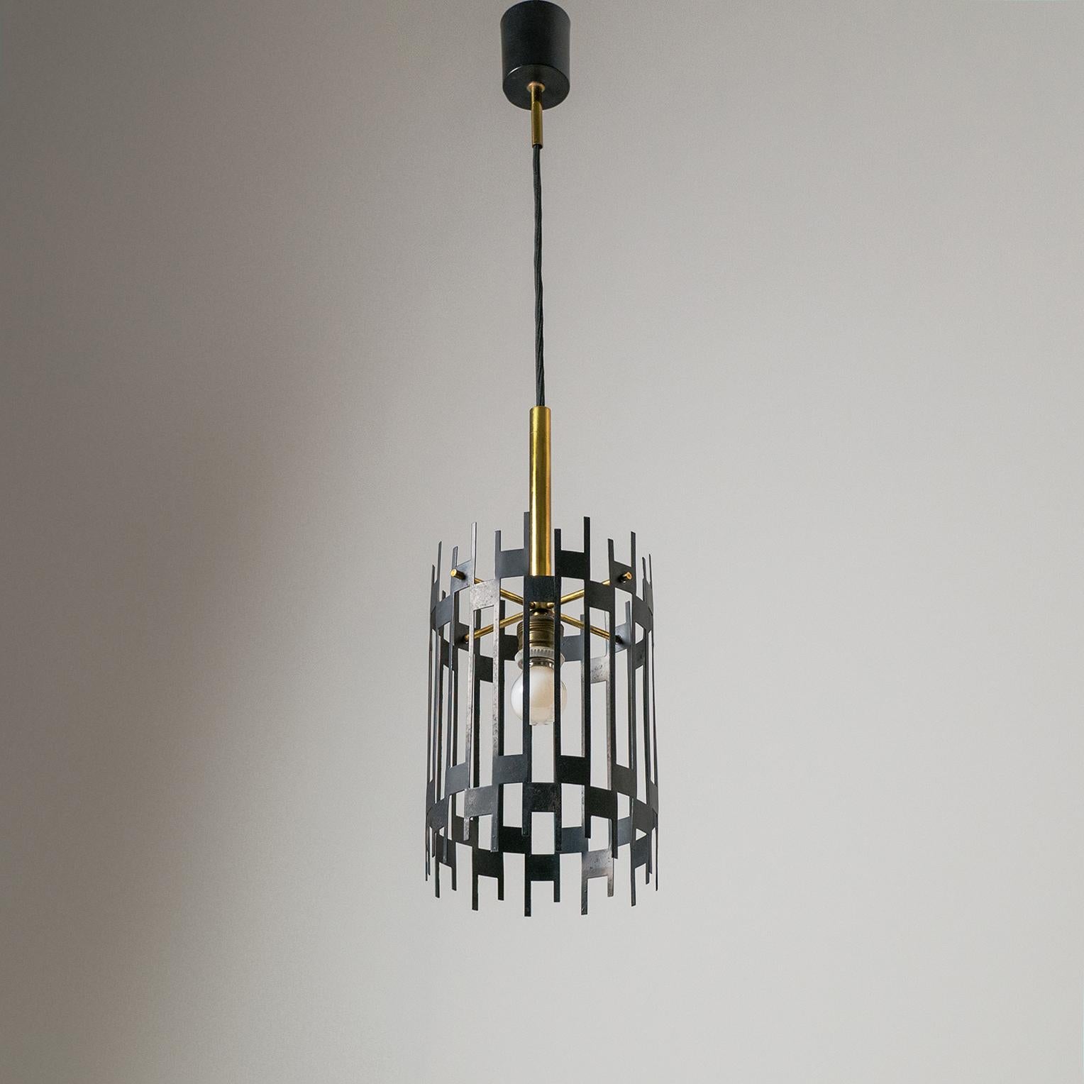 Very unique and rare Italian modernist cage pendant or lantern, 1950s. A geometric graphical black lacquered steel structure is fitted on a minimalist brass support enclosing a single bulb. Nice original vintage condition with some patina to the