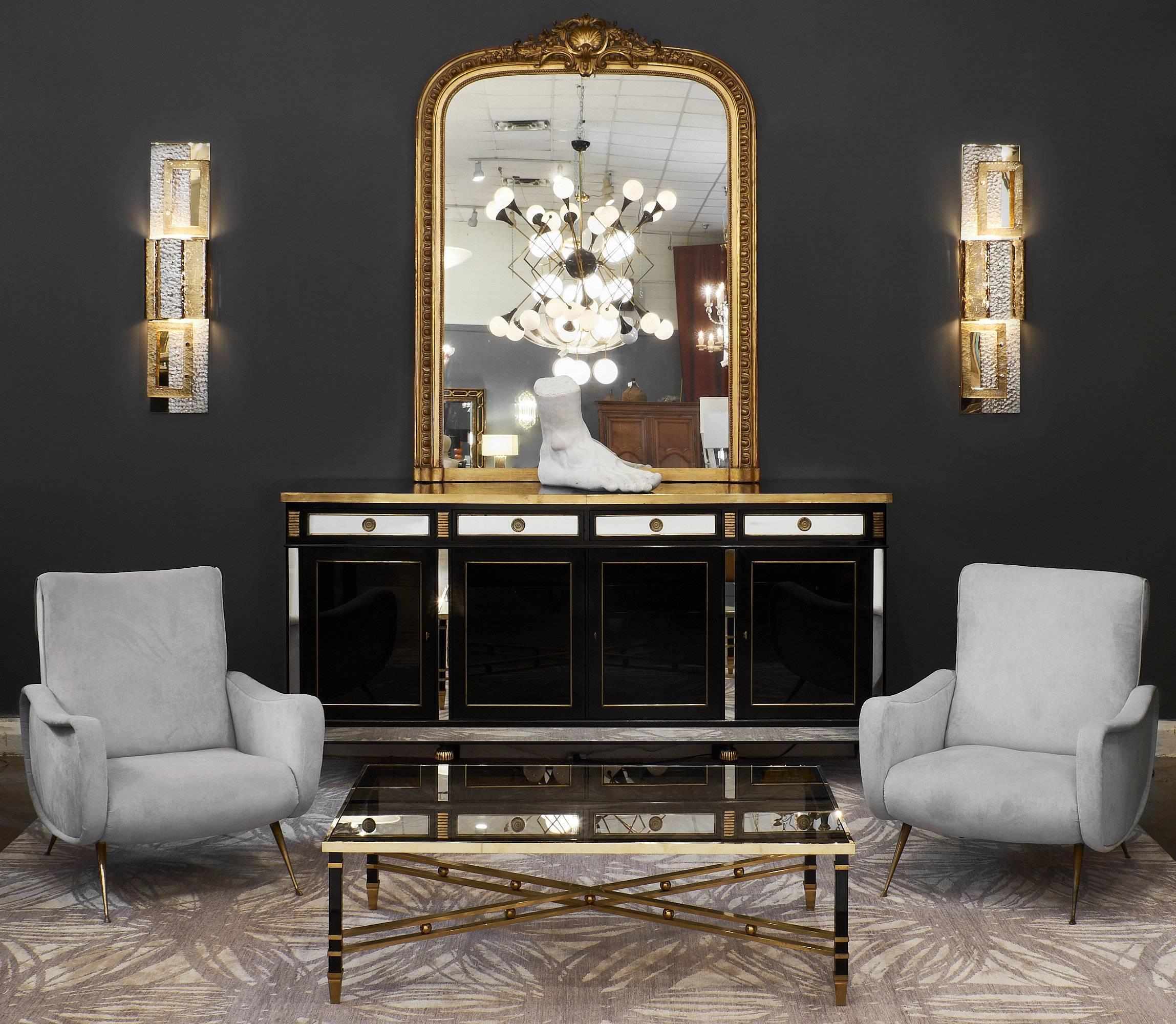 Italian modernist coffee table made of black lacquered steel and gilt brass. The piece has an X stretcher connecting four squared legs. Notice the solid brass spheres in the double brass stretchers and the perfect combination of brass and black