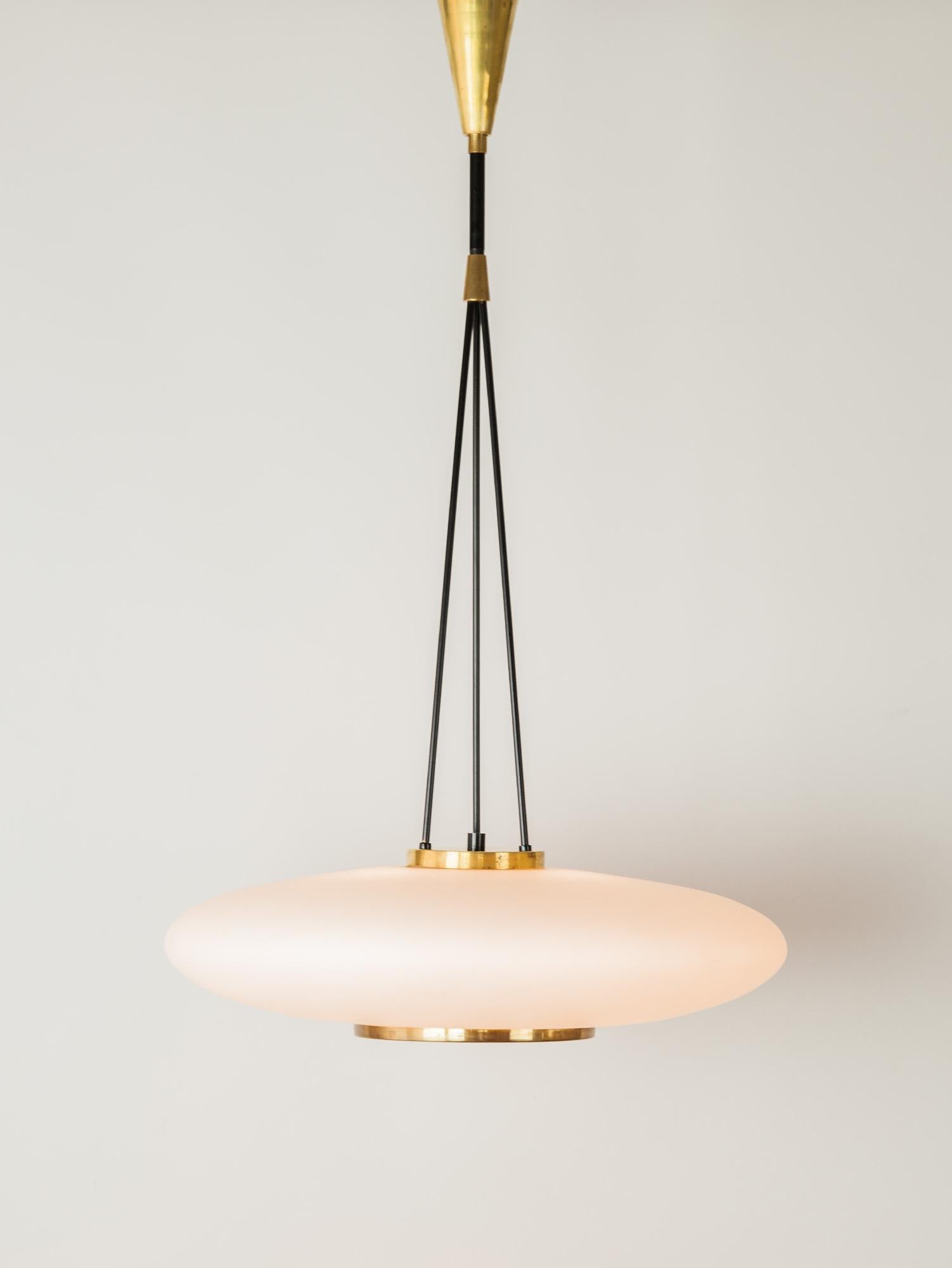 Rare and stunning Stilnovo modernist pendant with a glass shade and black and brass details. The round milky-white glass shade emits a lovely soft light and holds three E14 light bulbs. Lovely brass details are paired with the black enameled
