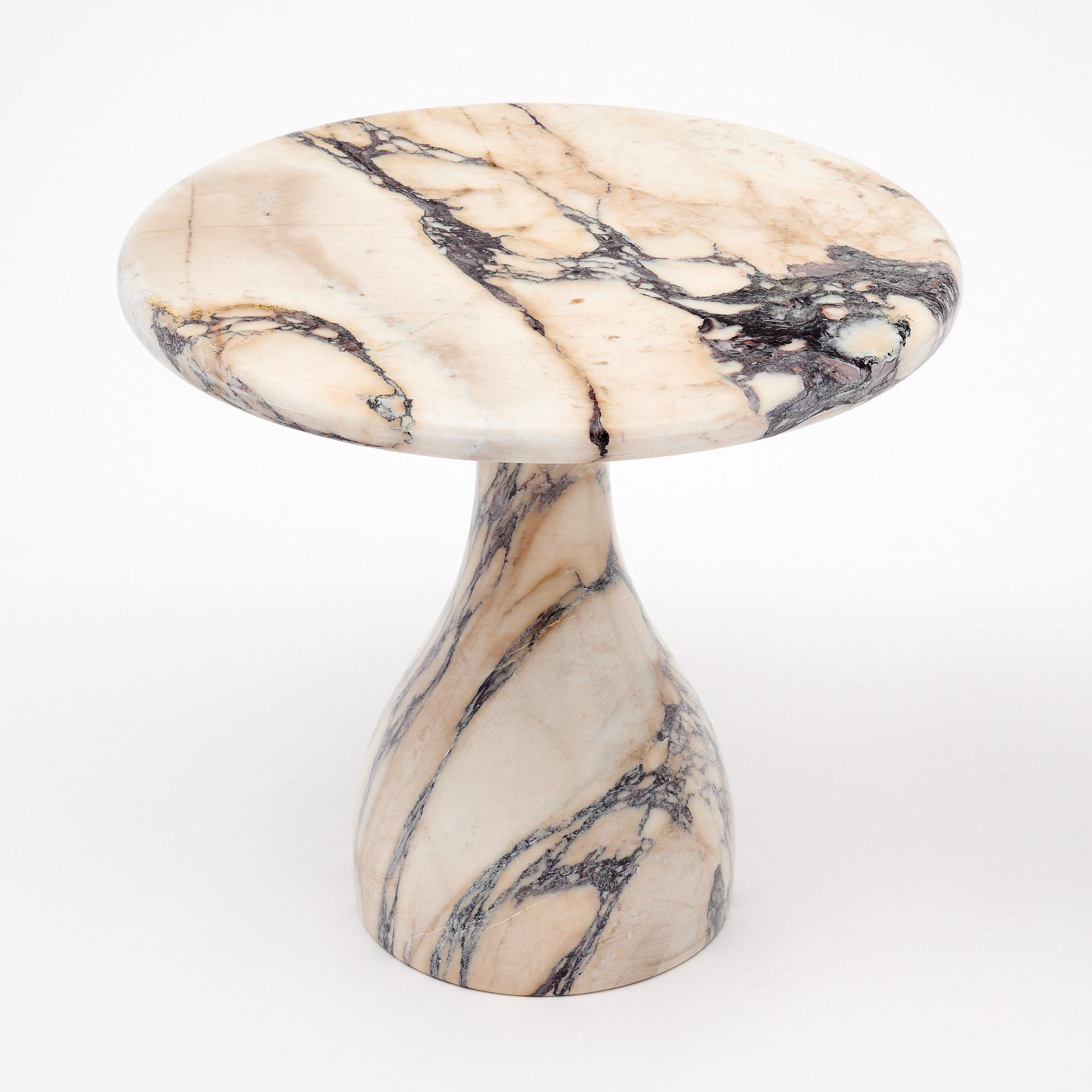 Side table from Italy in the modernist style. This table features a solid marble base with curved design and a solid marble top. It is made of Calacatta Viola marble with a strong veining throughout. It is in very nice condition – the photos