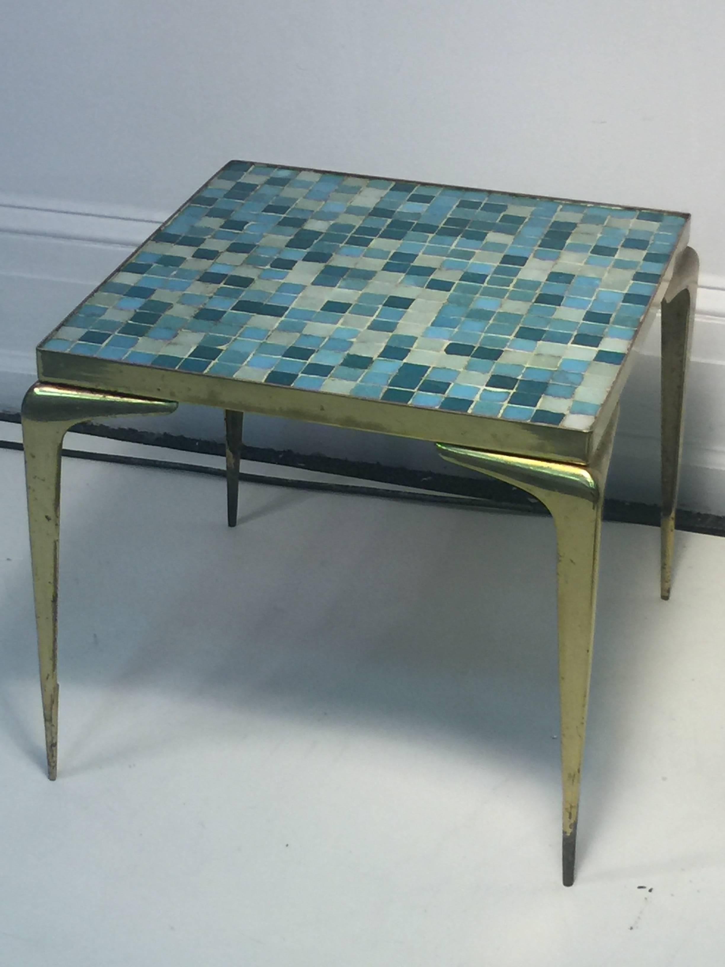 Italian brass framed table with top of aqua, cobalt and white Murano glass square tiles. Flared and tapered legs give this table a dynamic edge.
