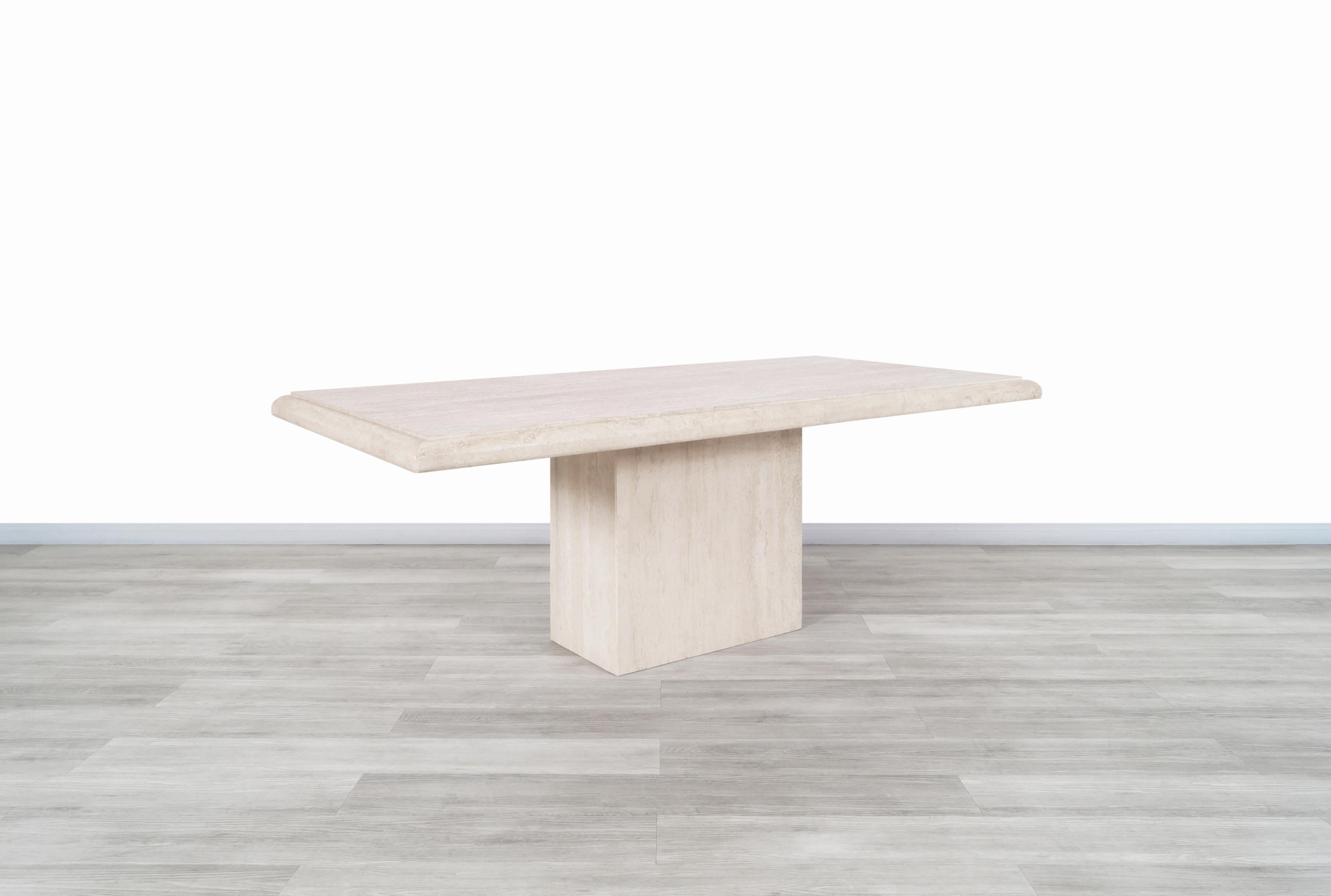 Exceptional vintage Italian travertine dining table manufactured in Italy, circa 1970s. This table has a design typical of the time and the place of manufacture where the minerals that make up the travertine stone stand out throughout its structure.