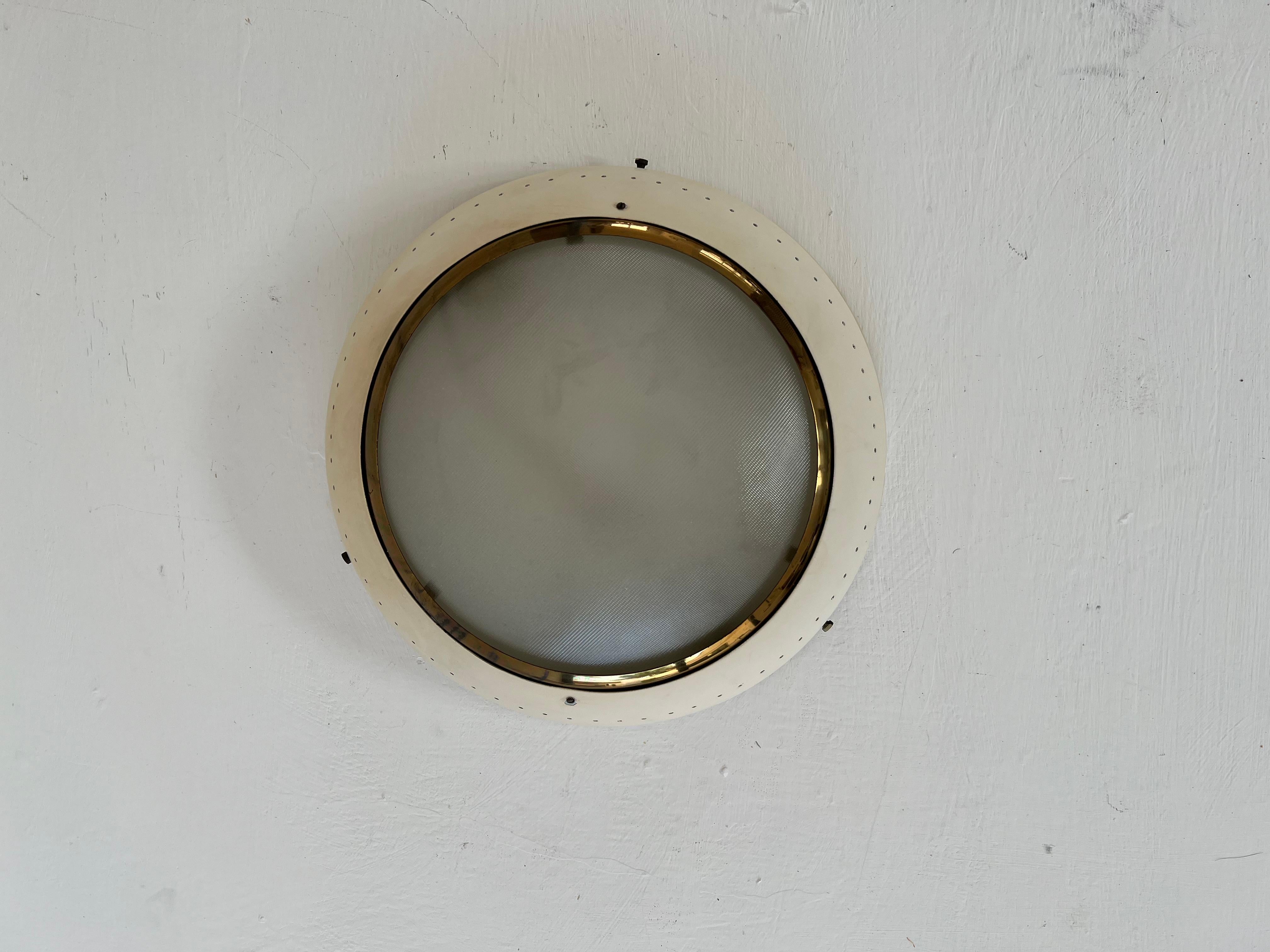 Beautiful and unique Modernist Flush Mount or Sconce.
This is manufactured in brass, pressed glass and aluminum and holds 2 e14 bulbs.
We have not been able to attribute it to any specific factory but the designand materials are very similar to