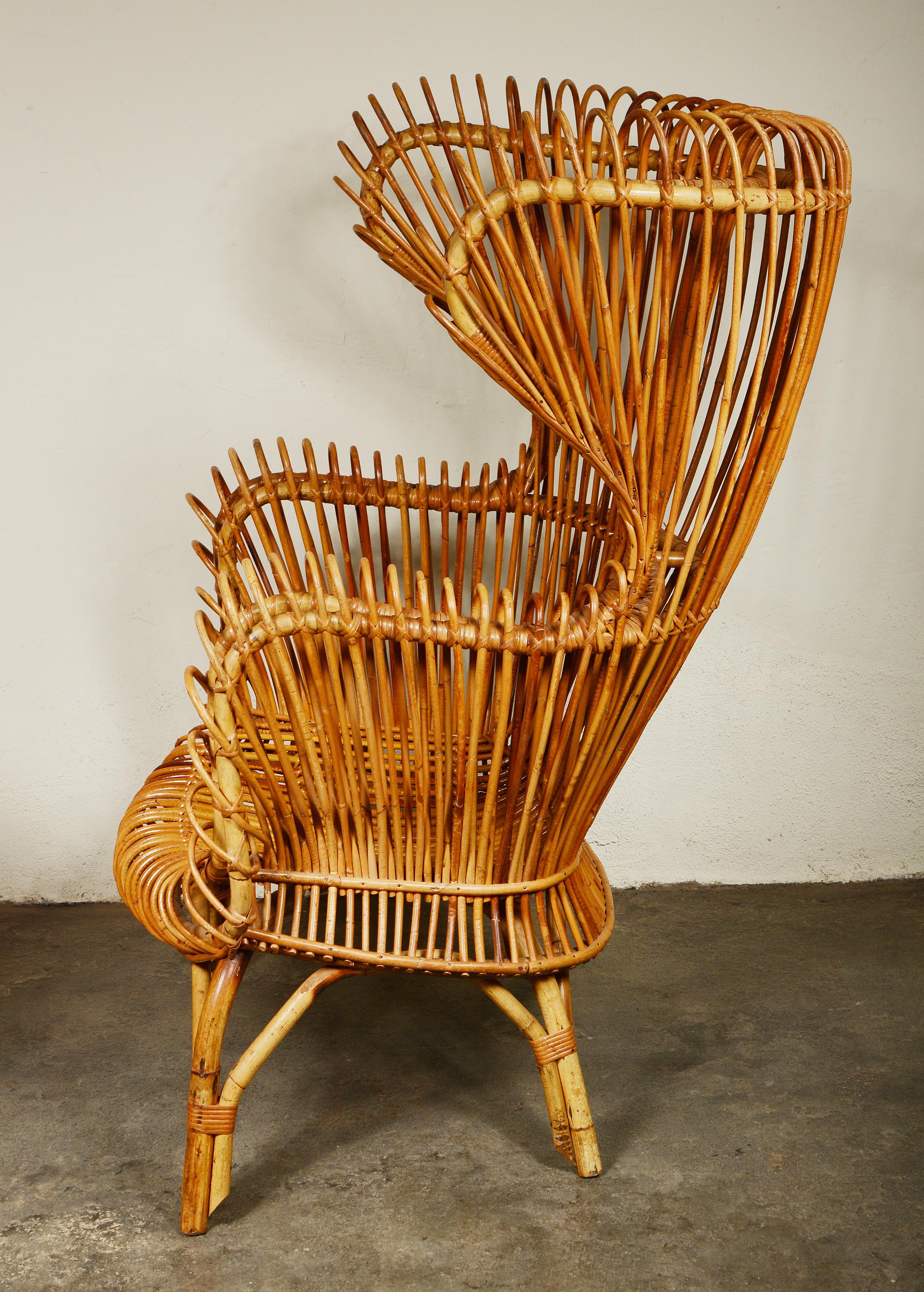 Tall wingback rattan lounge chair. This chair has some of the design elements found in chairs by Franco Albini for Bonacina. The chair is in very good condition. There are three or four small breaks to the wrappings. The chair may have originally
