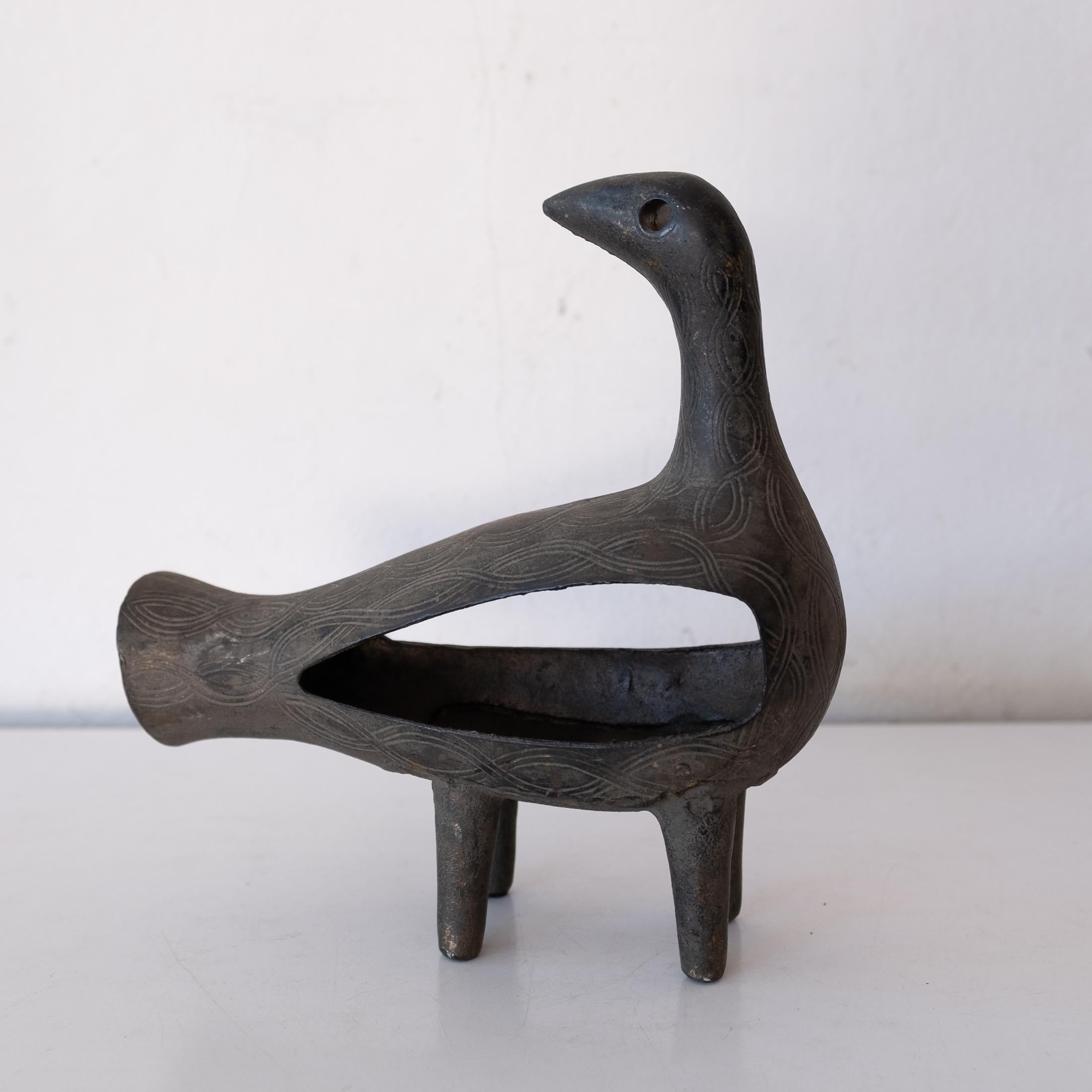 Stylized cast iron bird sculpture from Japan. Fantastic incised design. Could also be used as an incense burner. Nice patina throughout. Stamped JAPAN. 1950s