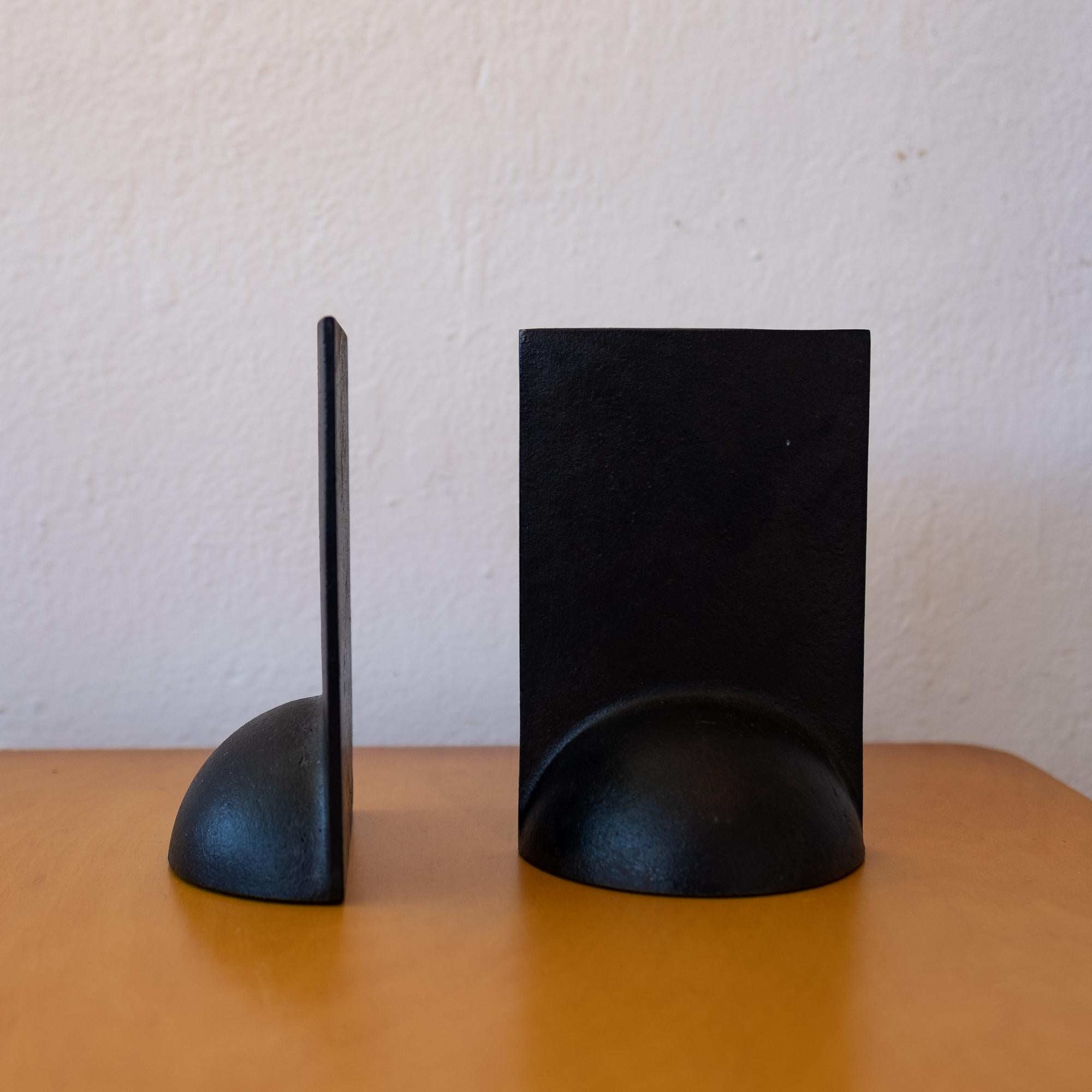 Modernist Japanese iron bookends. Solid iron with a nice patina. Made in Japan label on the bottom, 1960s