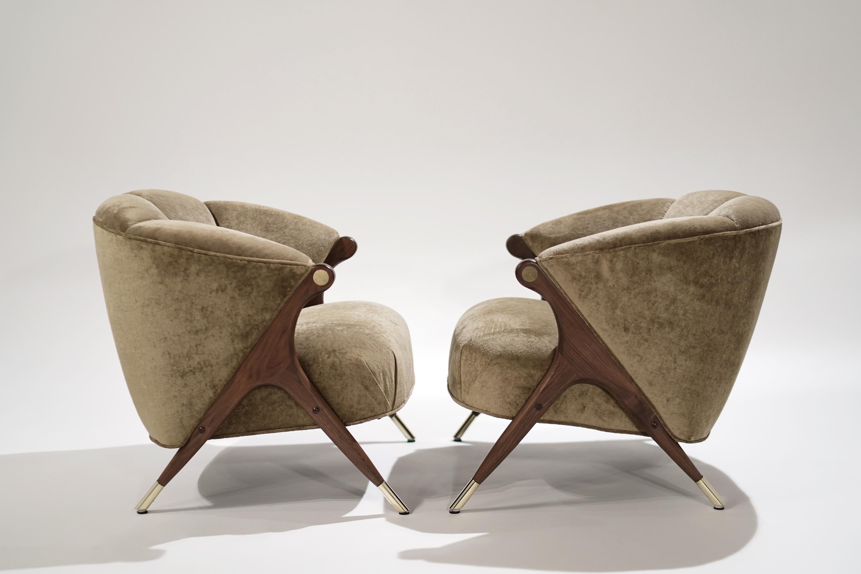 Capture the feeling of cozy conversation and forward momentum. These rare, vintage lounge chairs were made by The Karpen Company of California in the 1950s and artfully restored.
Solid walnut legs gleam with a natural finish and polished brass