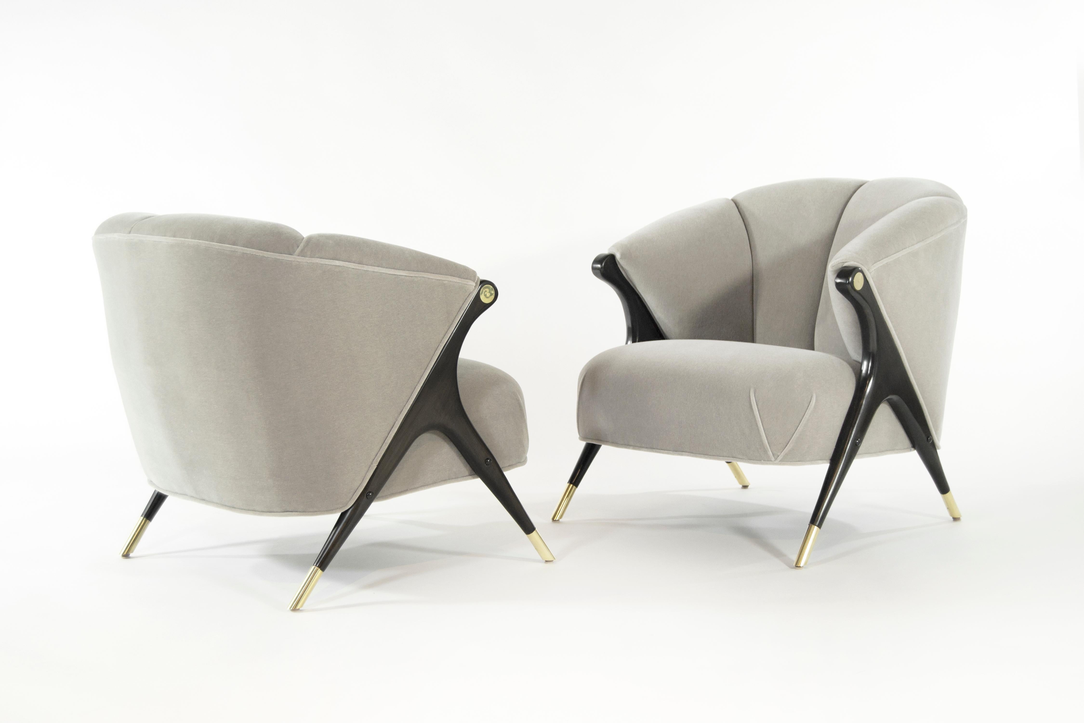 Stunning and rare pair of lounge chair by Karpen of California, circa 1950s.

Newly upholstered in grey alpaca velvet by Holly Hunt, sculptural maple legs newly restored to their original ebonized finish, newly polished brass sabots and arm