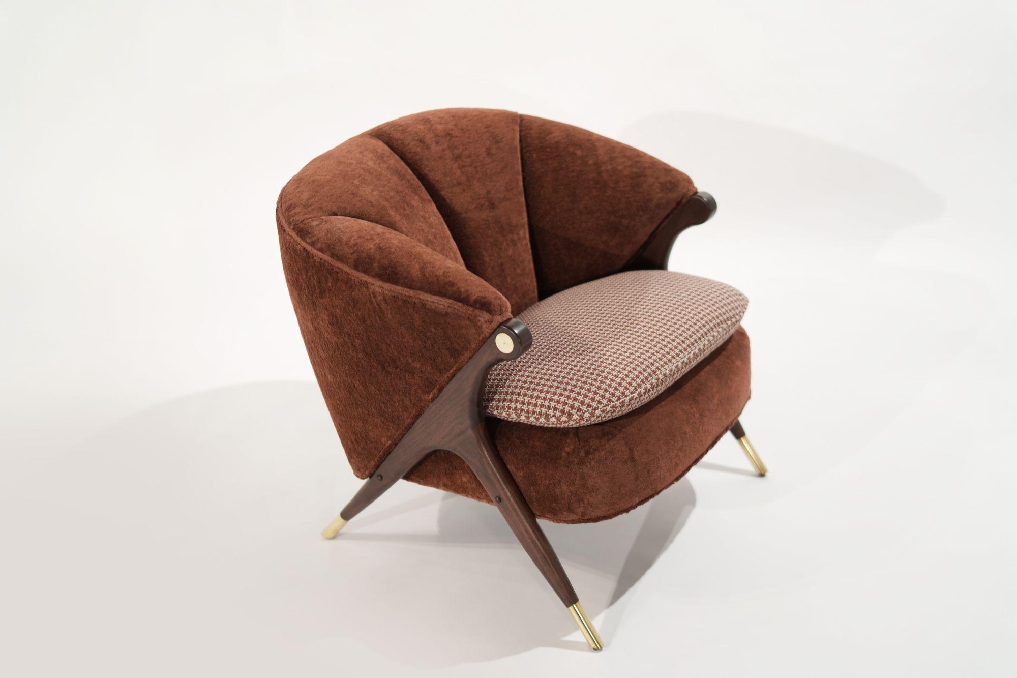 Capture the feeling of cozy conversation and forward momentum. This rare, vintage lounge chair was produced by The Karpen Company of California in the 1950s and artfully restored. Solid walnut legs gleam with our 
