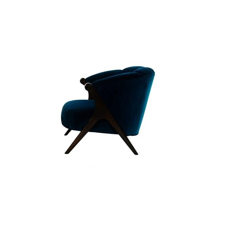 Midcentury modernist chair in the style of Karpen Bros. The barrel shaped chair features splayed ebonized walnut legs and has been newly upholstered in blue velvet.