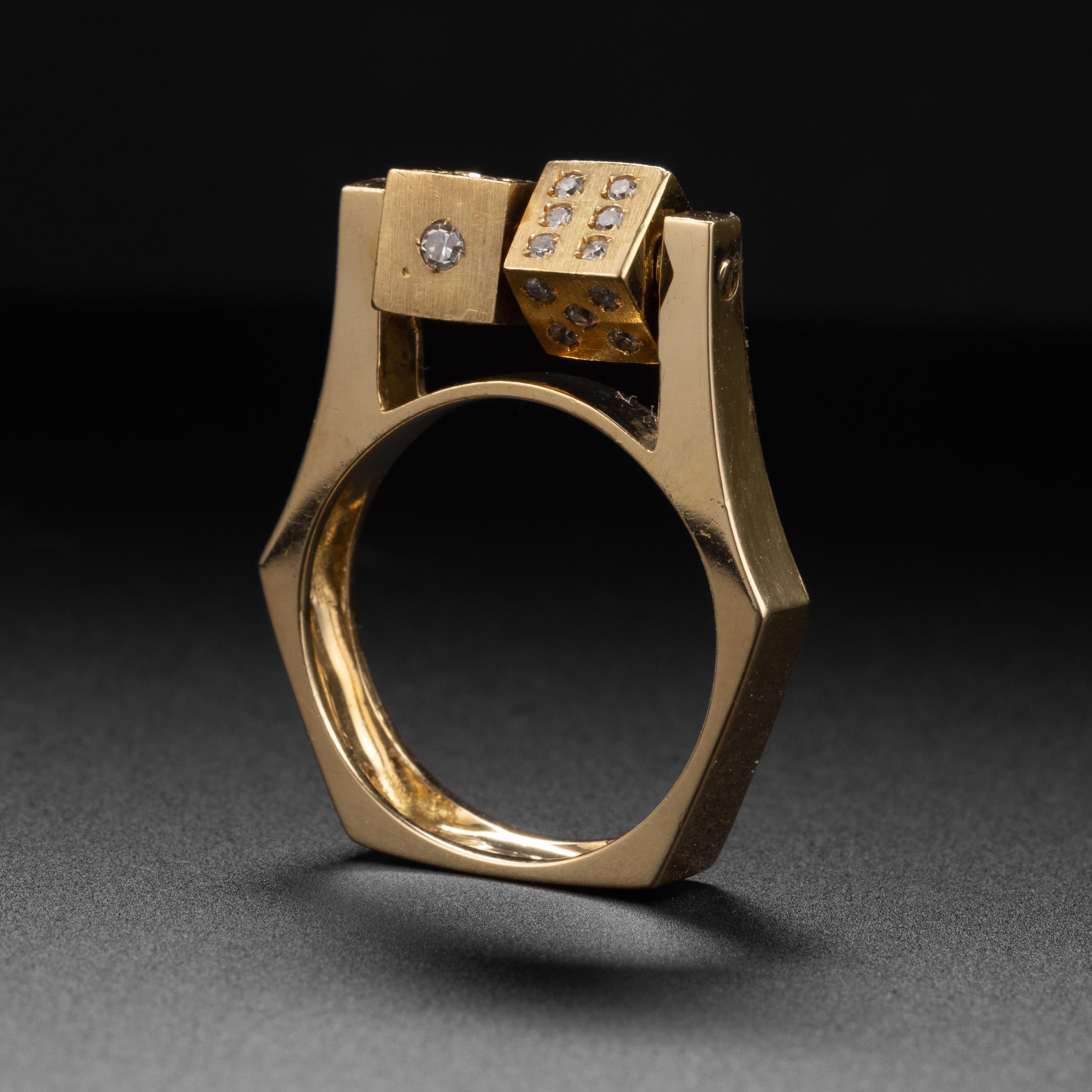 This modernist kinetic spinning dice ring is just spectacularly eccentric and unique. Everything about it is unusual: from the profile of the ring itself to the fact that it features a pair of dice that spin and instead of plain old boring black