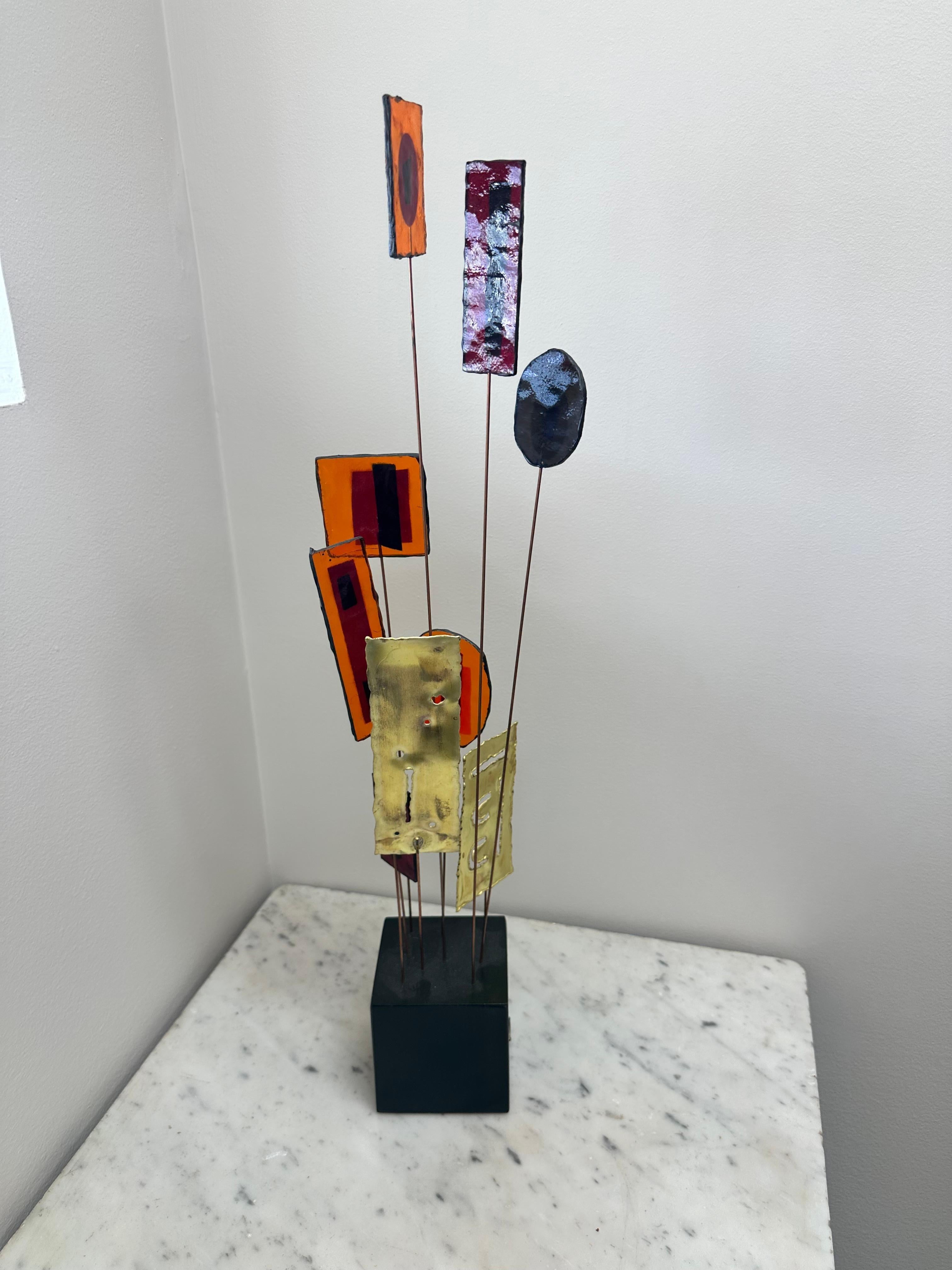 Modernist Kinetic Table Sculpture by C. Jeré  

An early and rare form 1960s fun and colorful kinetic table sculpture by Curtis Jeré. Brass and resin pieces mounted are on metal rods, and set into an ebonized wooden base. The base is mounted with a