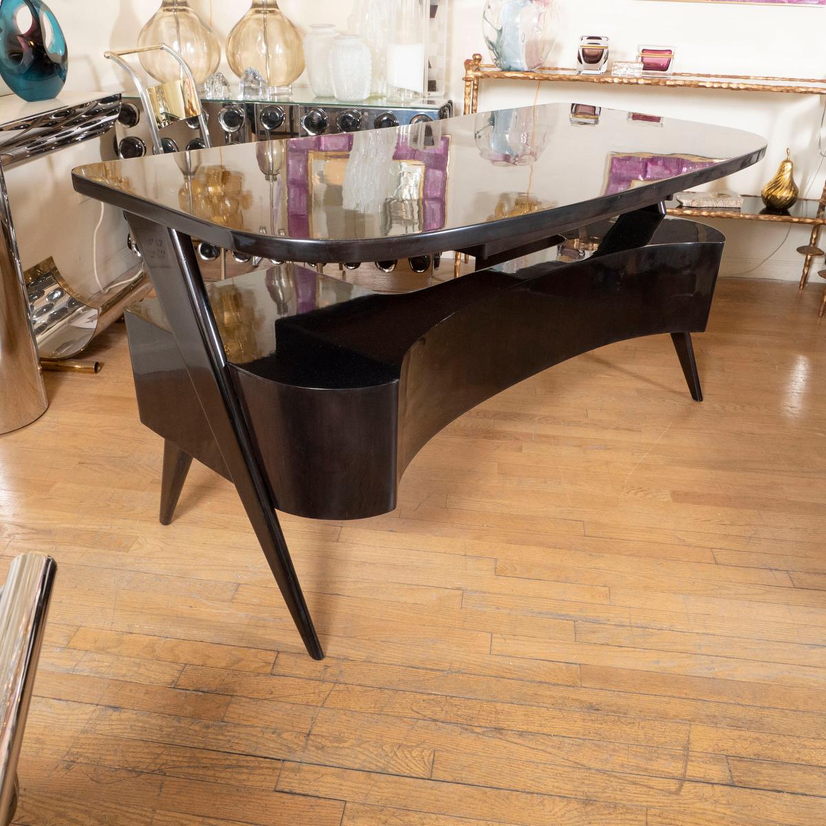 Modernist lacquered wood five drawer executive desk and with cantilevered top.