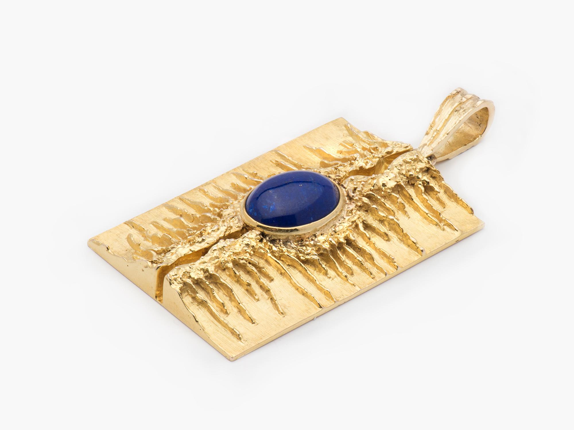 A unique 18k gold modernist pendant set with a lapis cabochon.