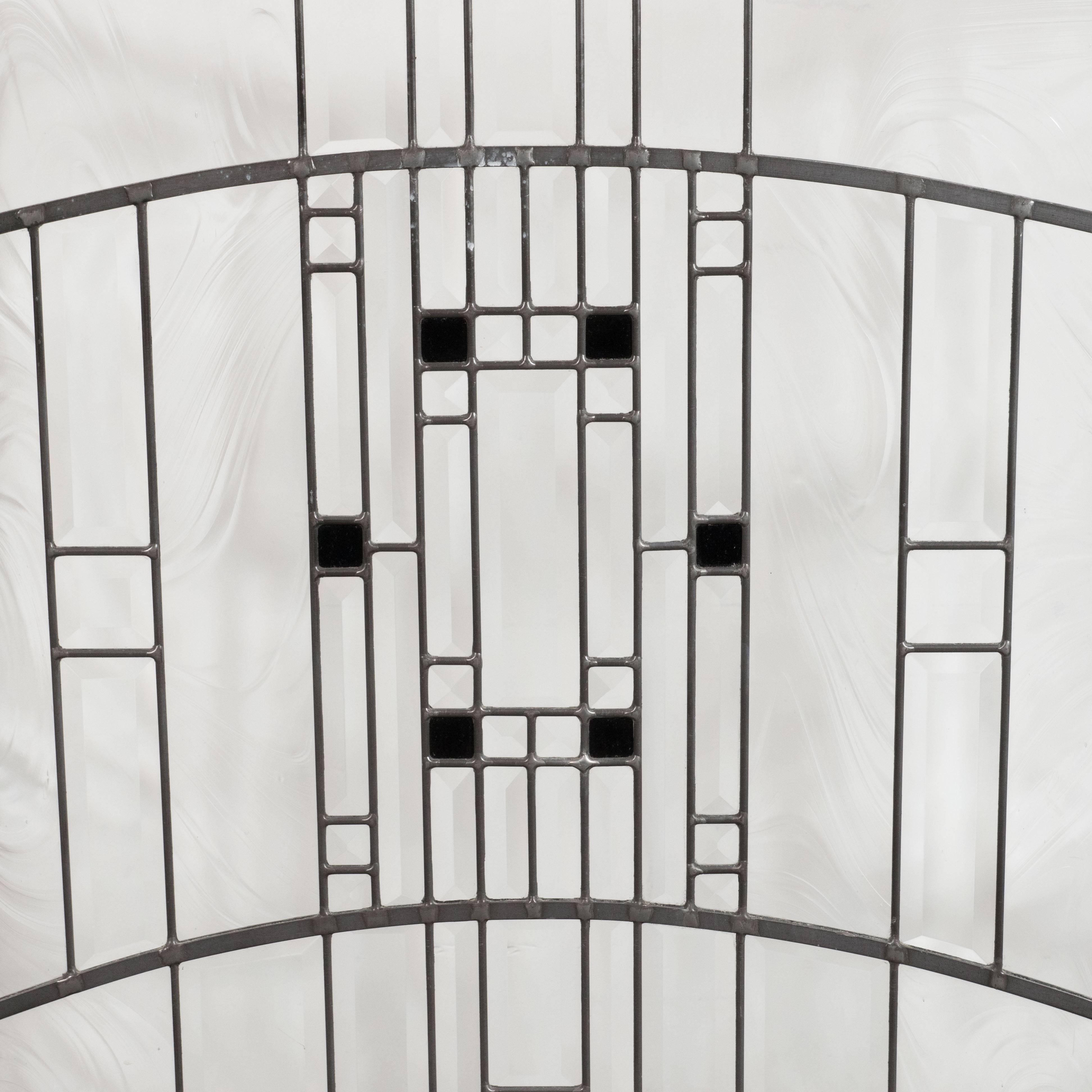 This elegant and refined firescreen represents a design produced by the legendary architect and visionary Frank Lloyd Wright. It features streamlined forms intersected by an abundance of vertical and horizontal lines, creating a wealth of beveled