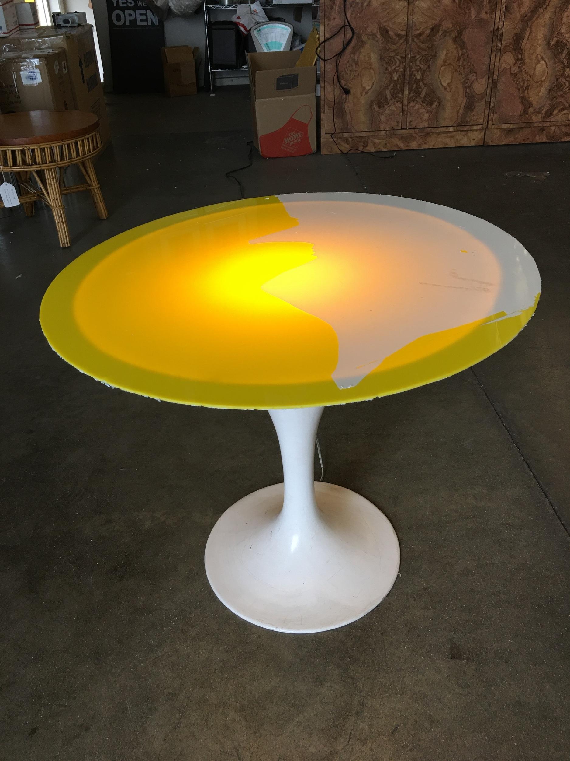 Rare light up midcentury table fashioned after the knoll tulip table. The table features a light-up table features a yellow acrylic top.