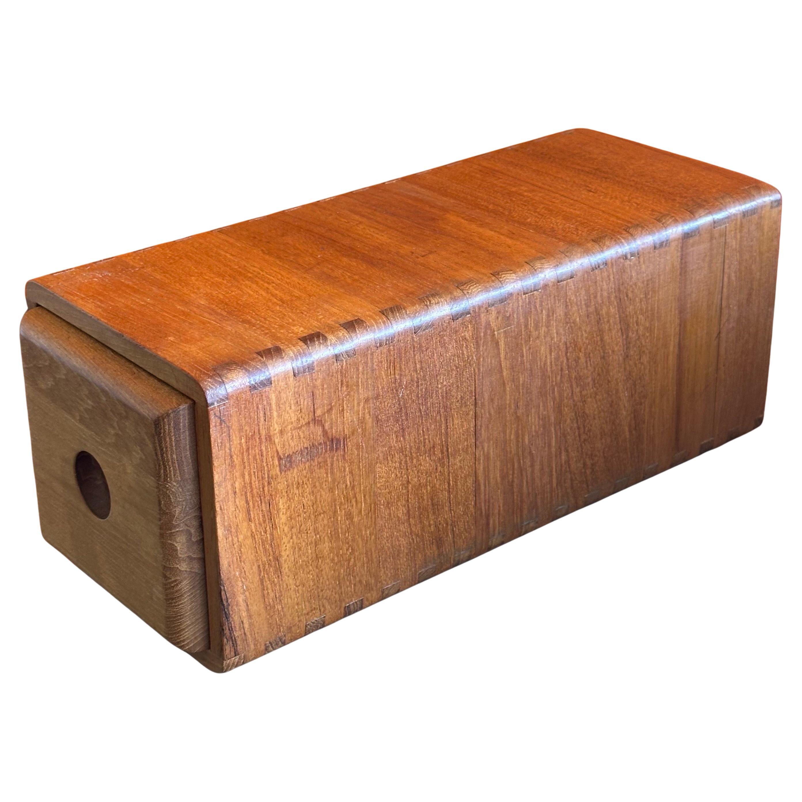 Modernist long solid teak storage box, circa 1970s.  This beautiful well crafted desk top box is great for storing small items. The box is in very good vintage condition and measures 5.5