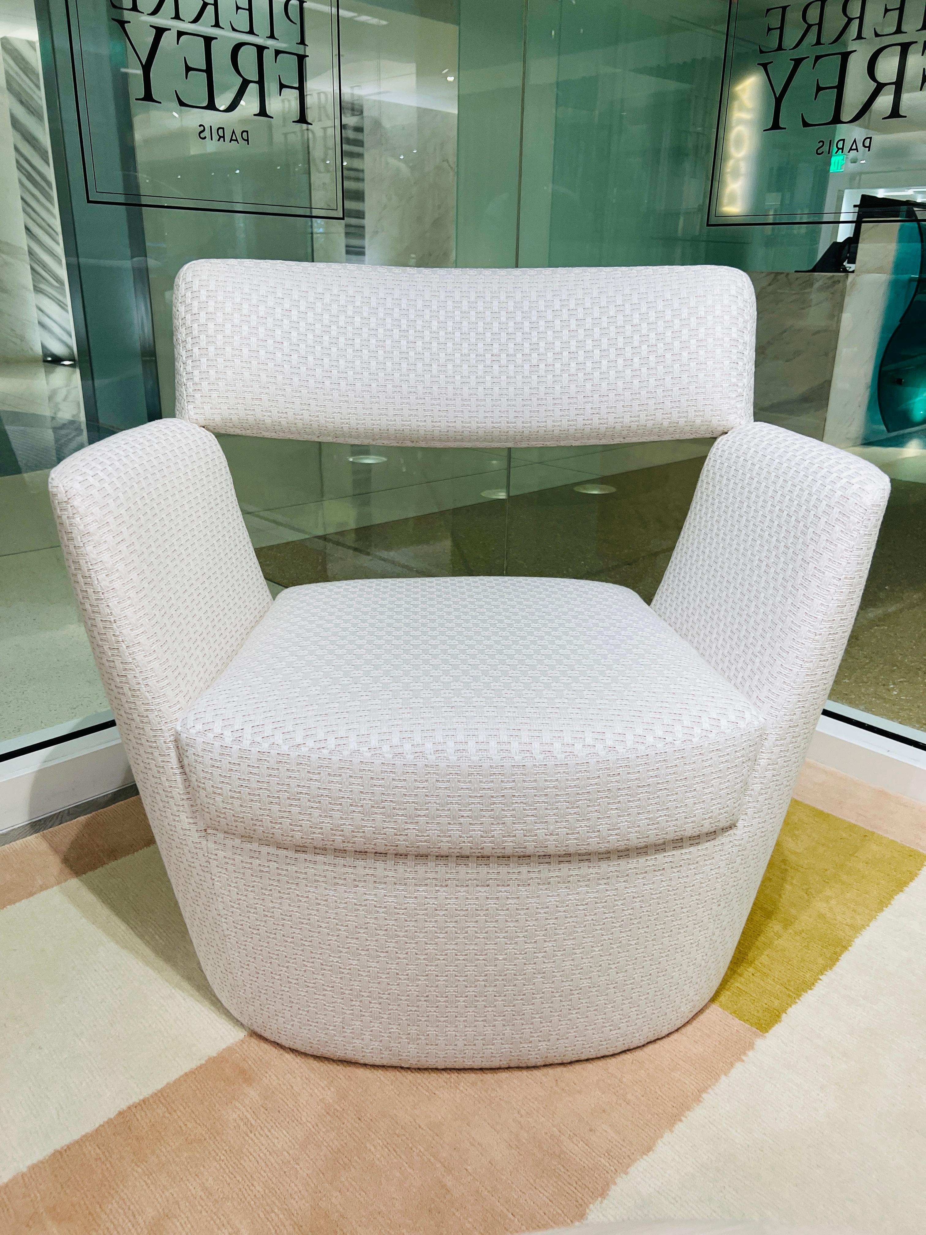 Contemporary armchair designed by Goncalo Compos for Pierre Frey. The modernist chair features a suspended backrest with graphic angular lines against a round base. Completely upholstered in Pierre Frey's Sete Chaux, a performance linen fabric that