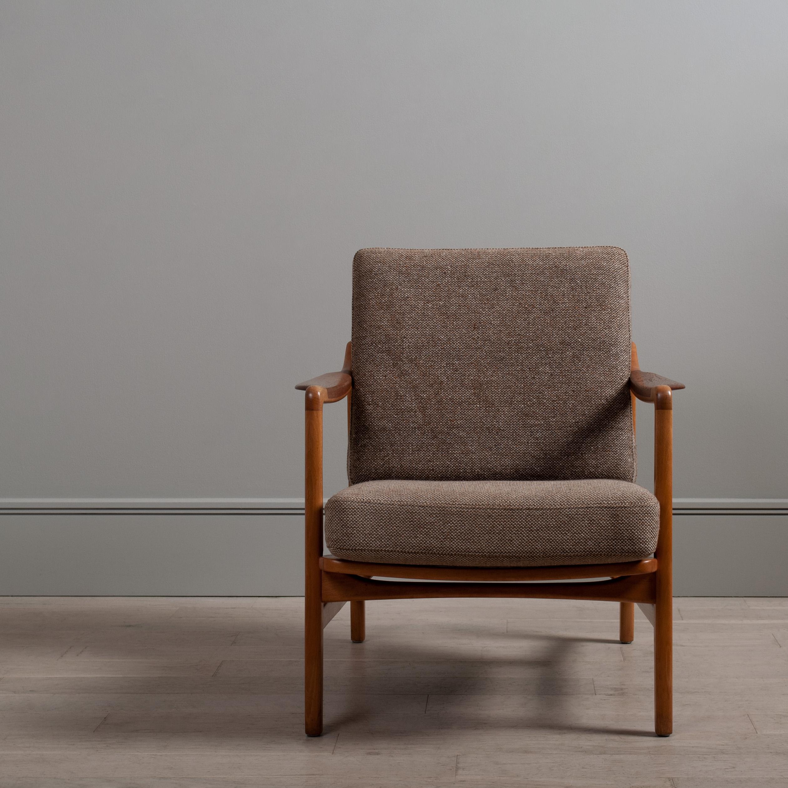 A superbly designed lounge chair by Tove & Edvard Kindt Larsen. Model 117 constructed from European beech with inset teak armrests. Price includes reupholstery in fabric colour of choice from the Isle Mill Fabric - Leather upholstery for small