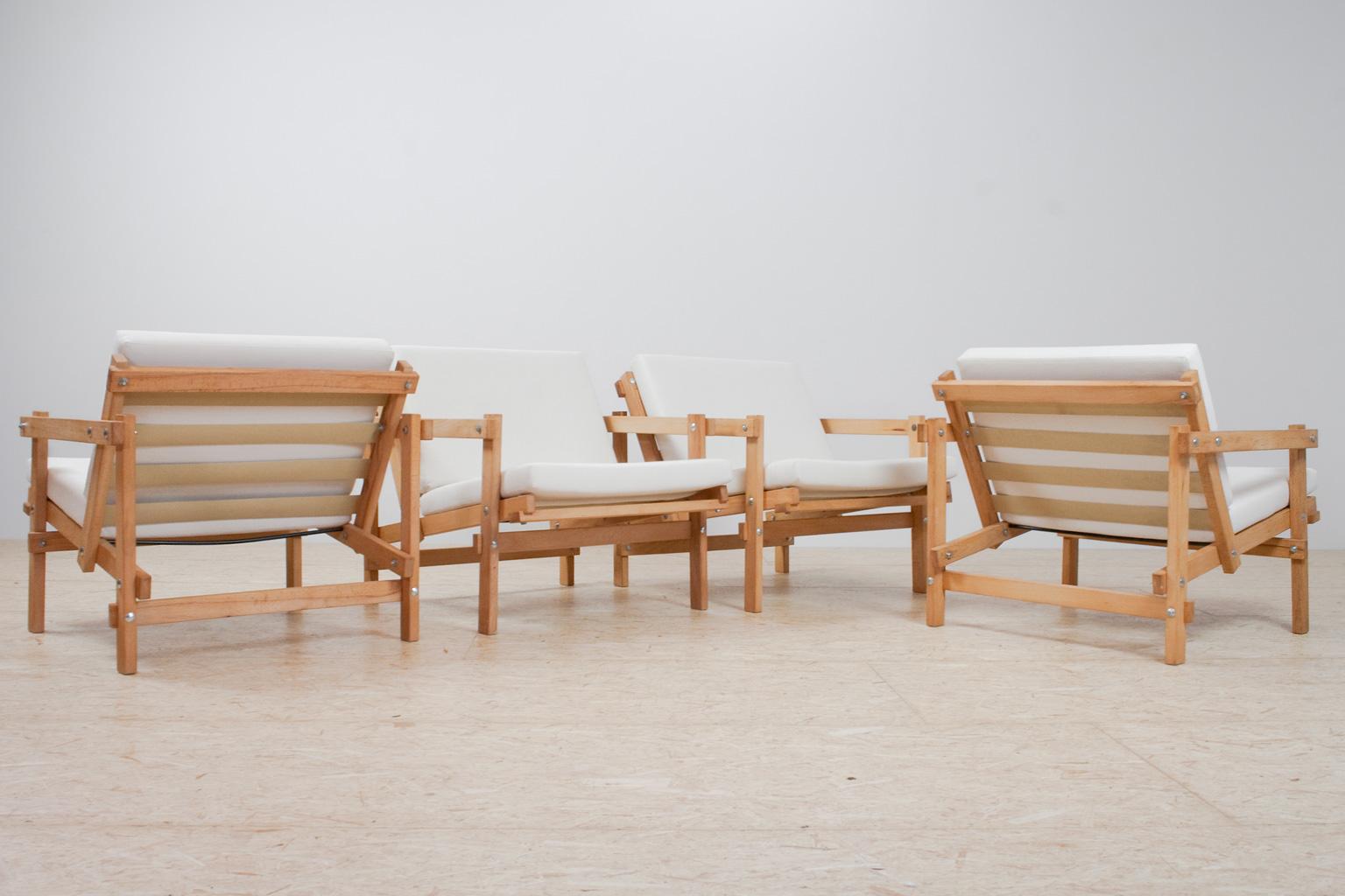 Great visual constructed set of four lounge chairs in beautiful natural beech wood, designed in the 70s by Martin Visser. The geometric shaped chairs have a really great comfort and makes for a visual attractive and quite rare object in your