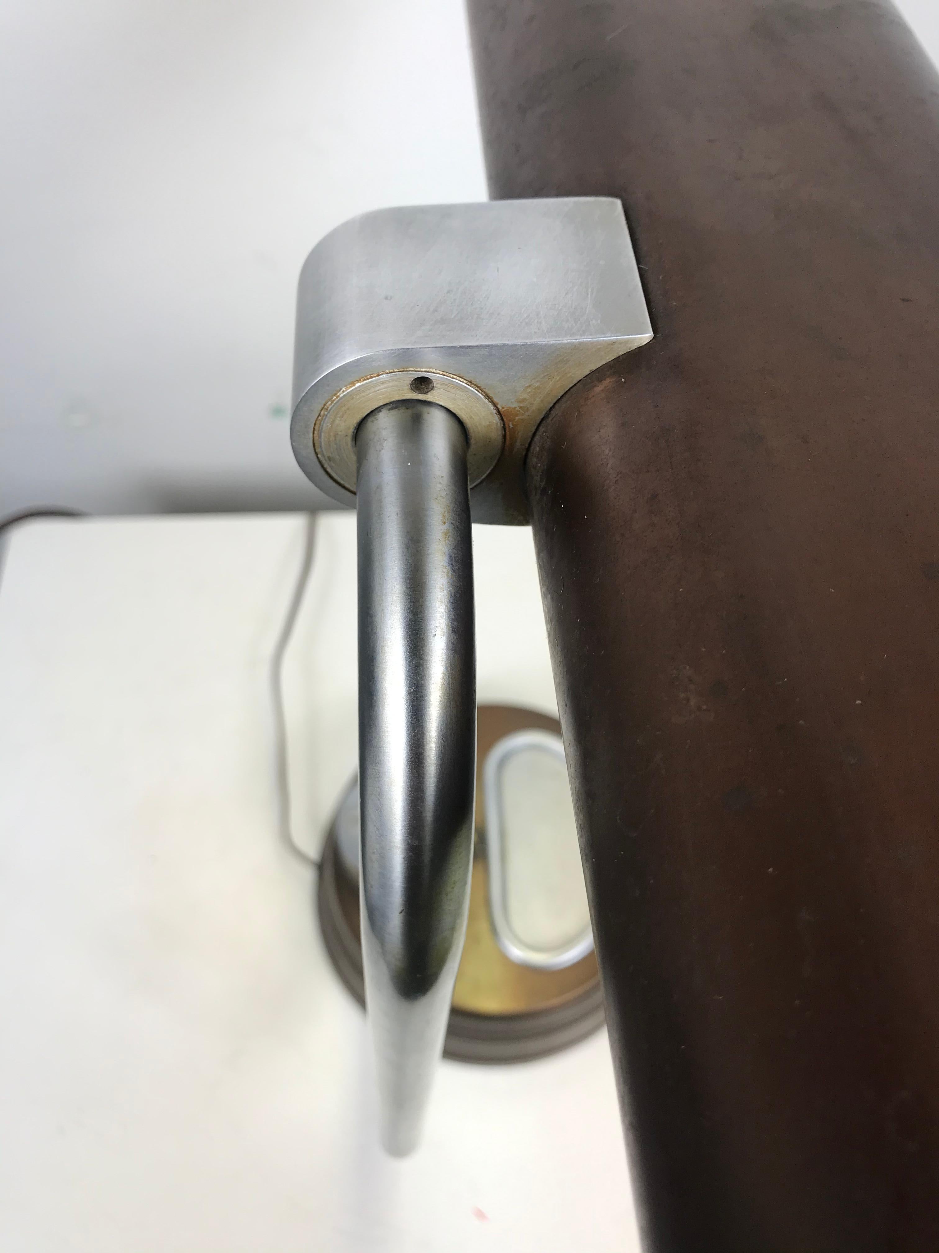 Unusual modernist, machine age stainless steel / metal industrial desk lamp, circa 1930s, reminiscent of glorious designs of Gilbert Rhode, KEM Weber. Warren McArthur etc. Beautiful machined construction, industrial yet elegant design, adjustable
