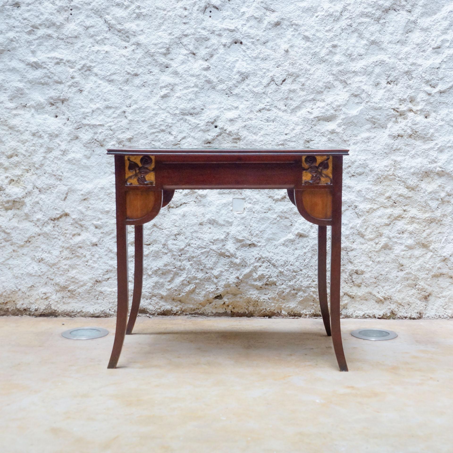 Modernist wood table with upholstered top, circa Early 20th Century.
By unknown manufacturer from Spain.

In original condition, with minor wear consistent with age and use, preserving a beautiful patina.

Material:
Wood
Fabric

Dimensions:
 D 55 cm