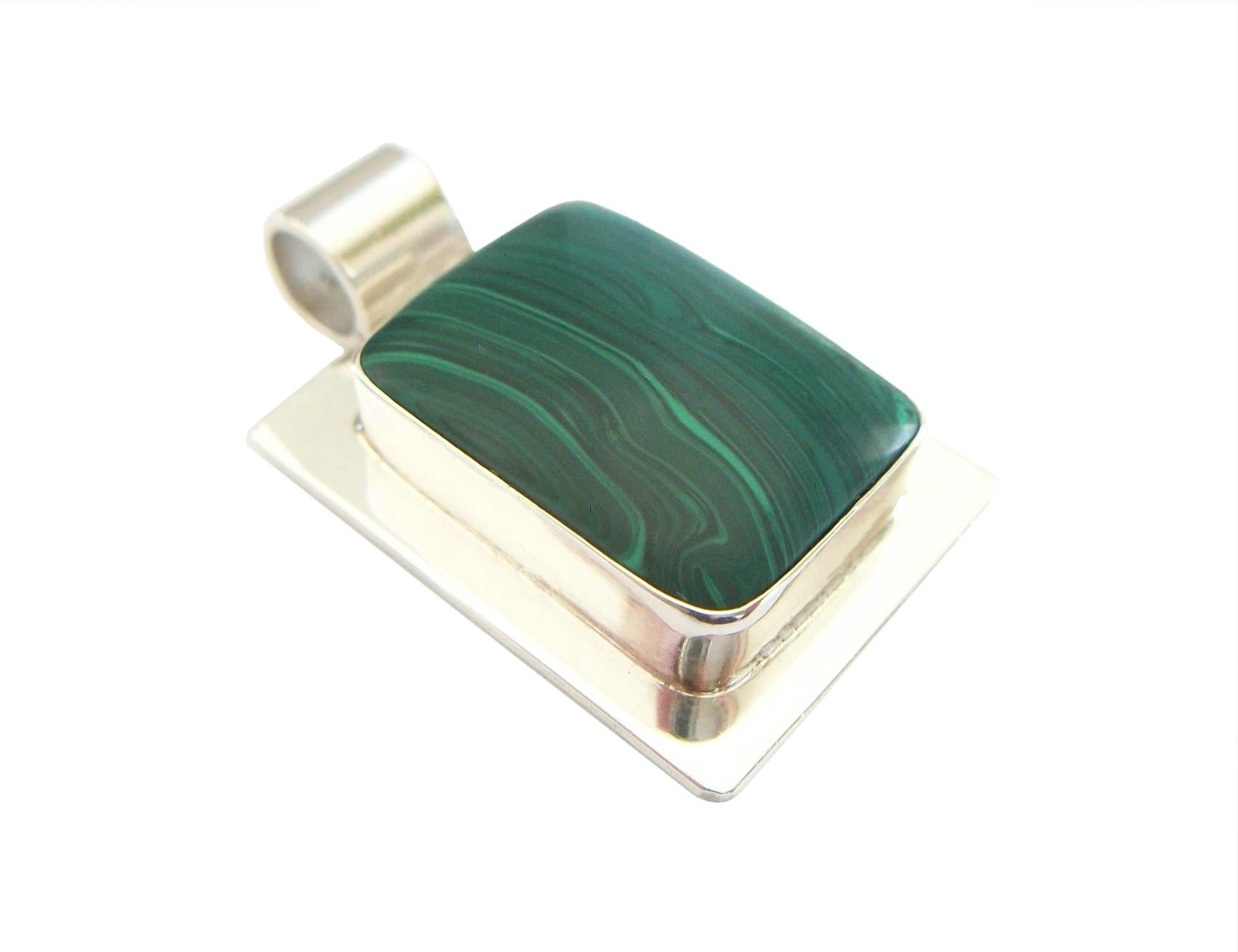 Modernist Malachite and sterling silver unisex pendant - featuring a large polished bezel set cabochon Malachite gemstone (approximately 30 carats - 28.0 x 20.0 x 5.0 mm.) - large bale (7.0 mm. diameter - fits a large cord or chain) - no chain -