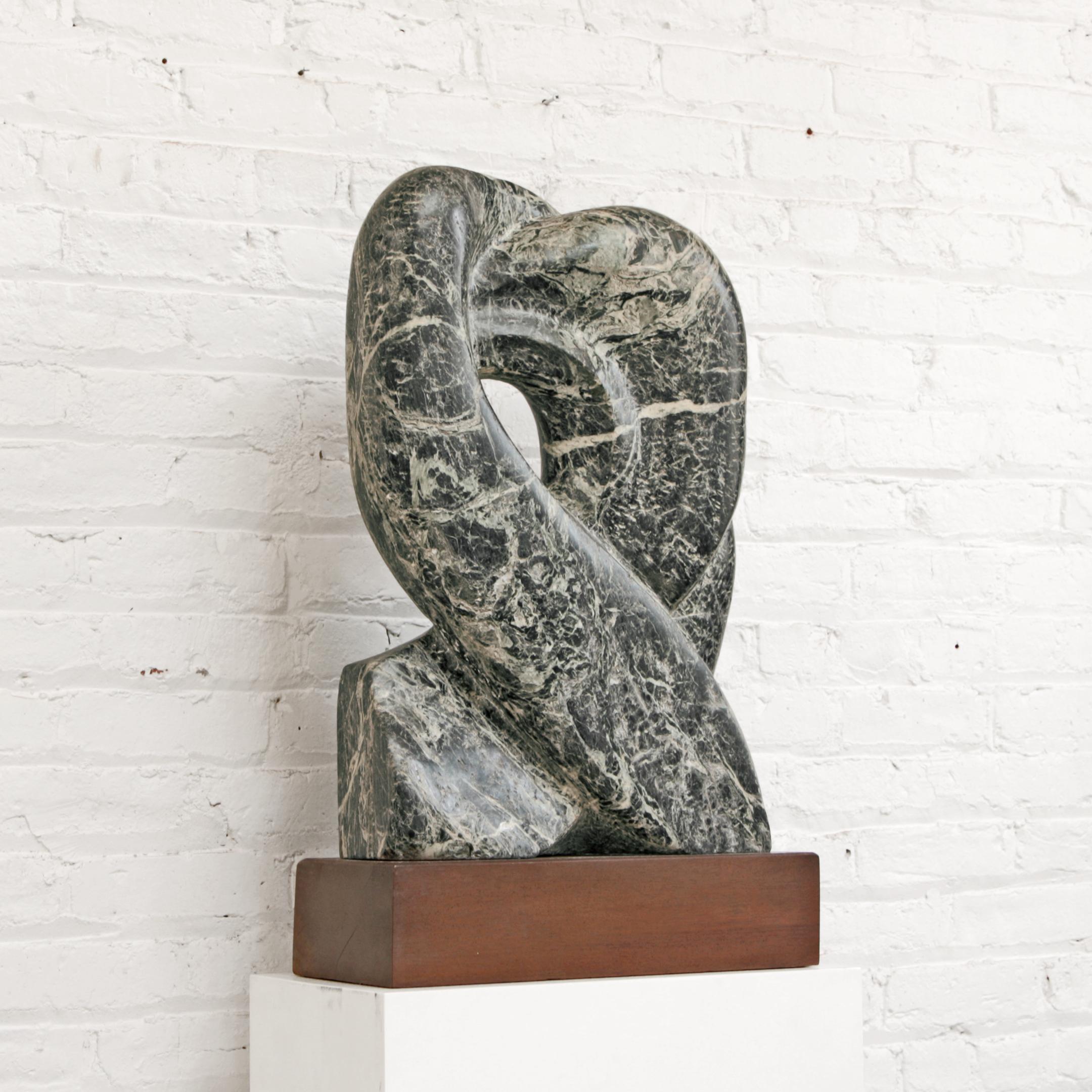 Modernist marble sculpture. Blue, green, grey and white marble sculpted in abstract organic form mounted on wood pedestal.