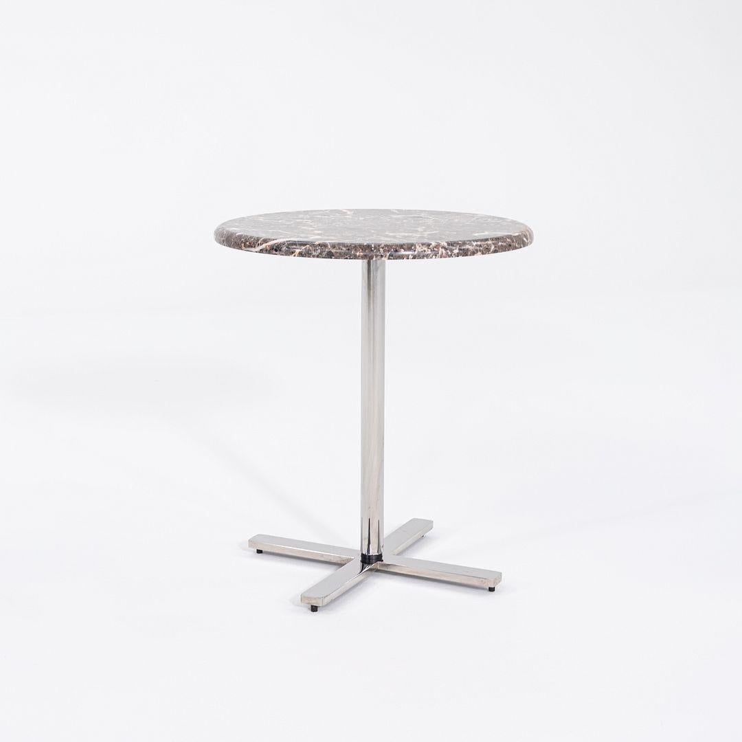 This is a Marble Side Table with a base that is solid and polished stainless steel. The top appears to be Brown Emperador marble or a similar stone. This piece is unmarked so the exact designer and manufacture are unknown.

The table measures 18.25