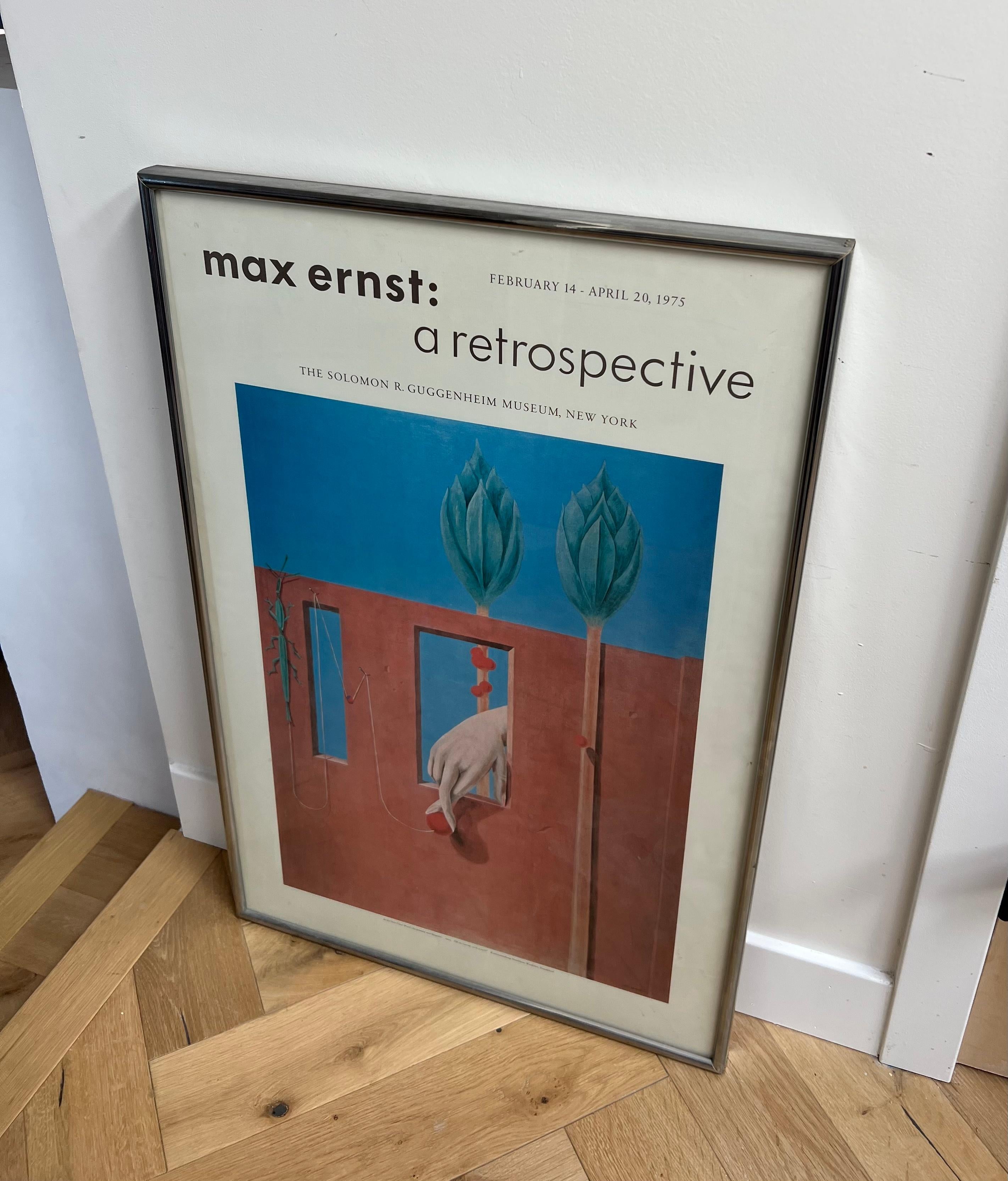 An original exhibition poster from the Solomon R Guggenheim museum in New York City: “Max Ernst: a Retrospective.” From 1975. This poster showcases the artist’s work “At the First Clear Word” (Au Premier Mot Limpide), oil on canvas, 1923. Having