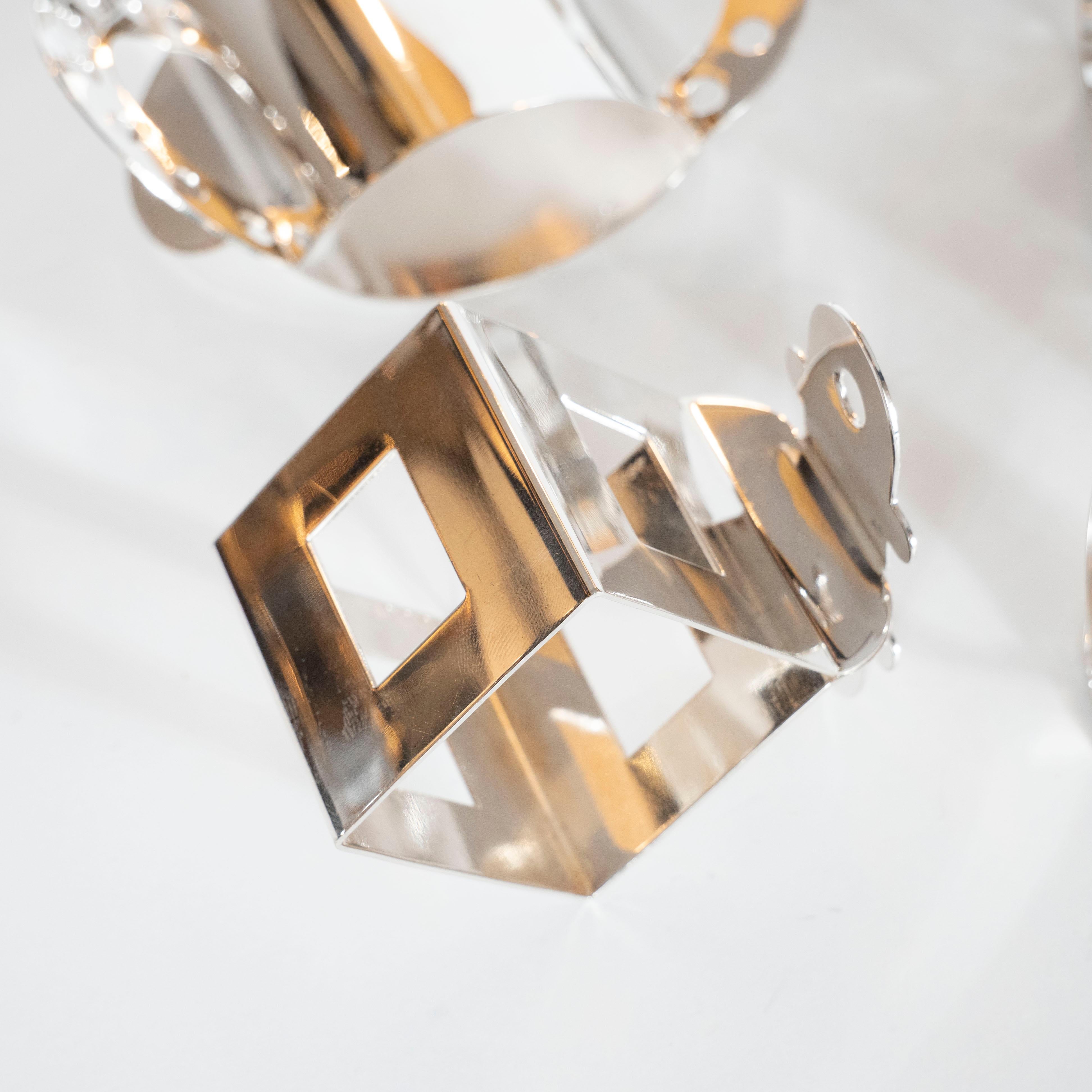 This set of 11 silver plate napkin rings was designed by Nathalie du Pasquier for Bodum, circa 1980. Pasquier, an influential Milan-based artist and founding member of the Memphis Group, is best known for her Postmodern textiles, furniture, and