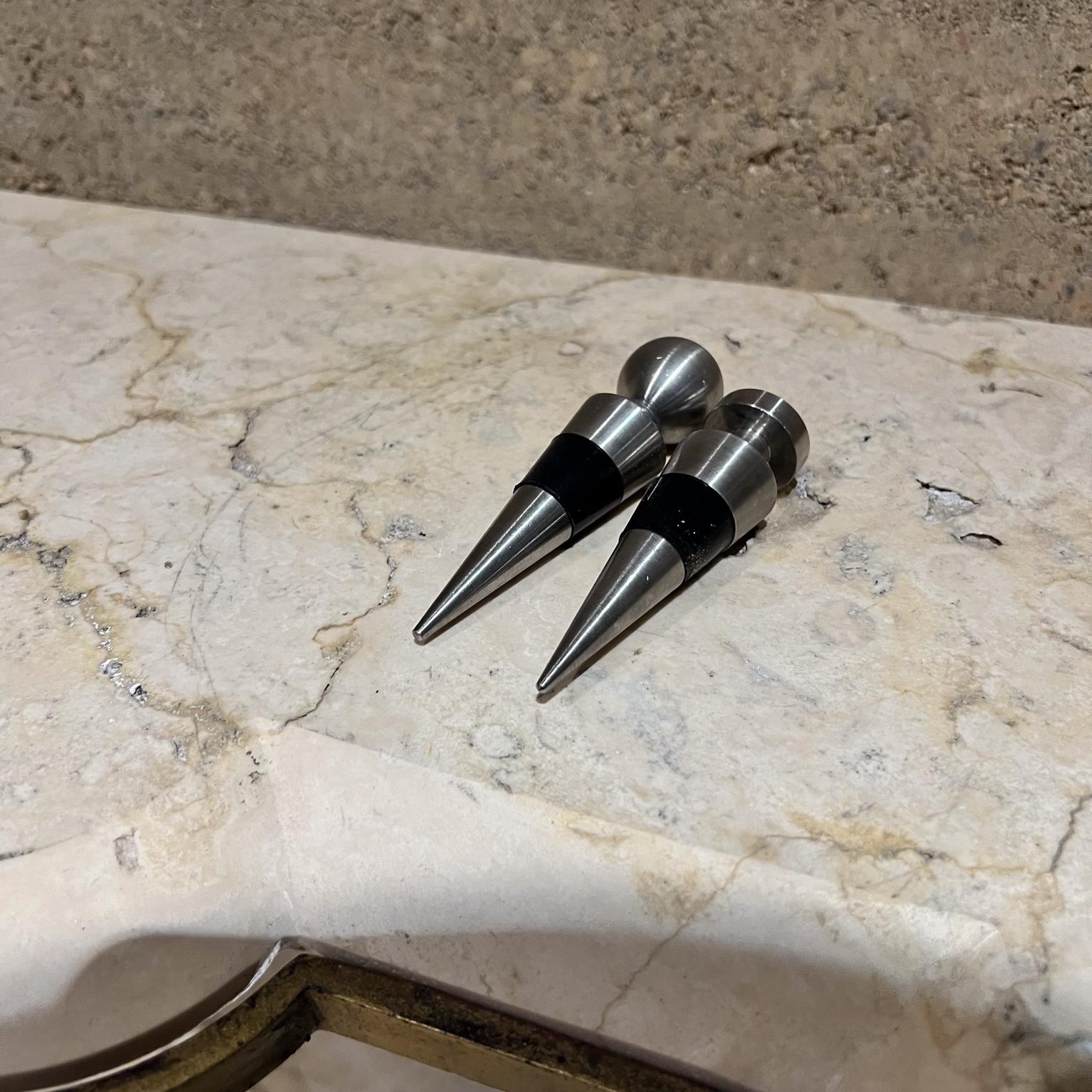 1970s Modernist Metal Wine Bottle Stopper Set of Two
4 long x 1 diameter Short 3.25
Original vintage
Refer to images please