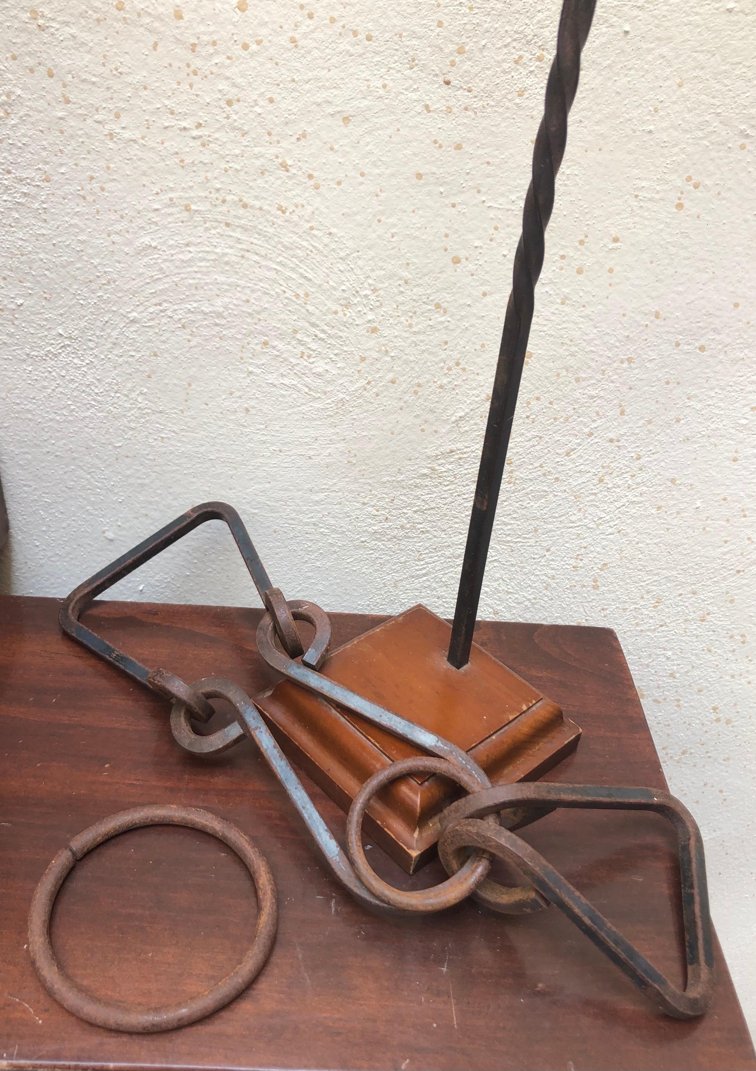 This unique iron sculpture from Mexico, circa 1970´s. 
Solid walnut base holding iron puzzle with the purpose of getting free the large ring out of the puzzle. 
  