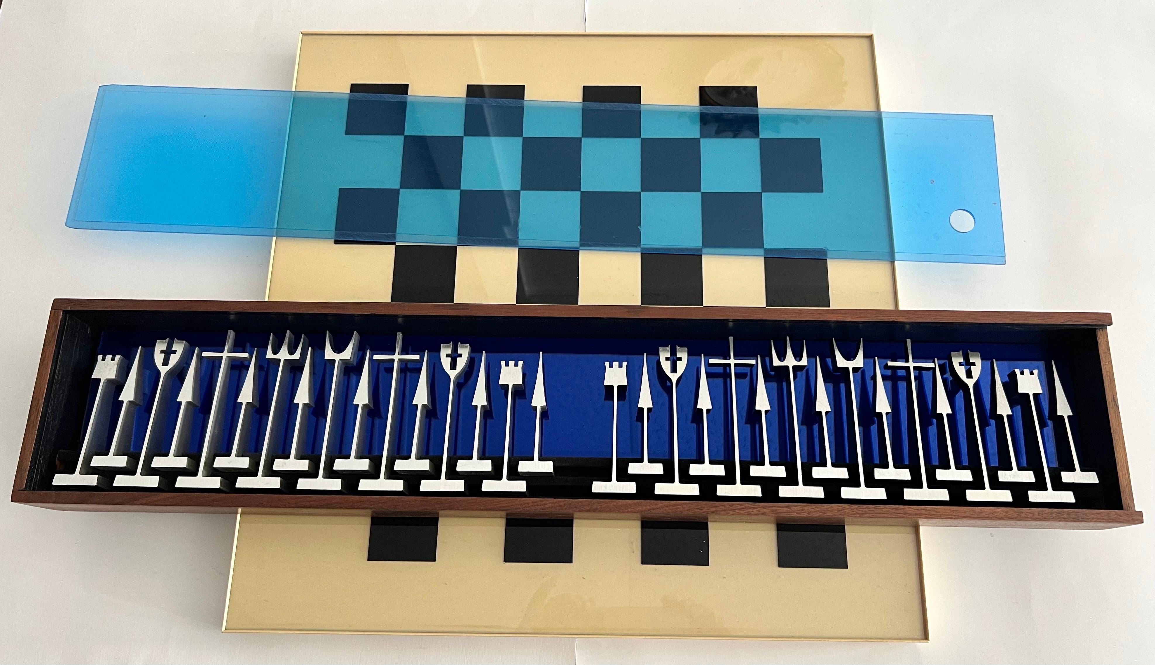 Extraordinary mid century chess set by Austin Enterprises. Original board. The case has walnut exterior. Interior black with blue mirror. Clear blue lucite cover. 