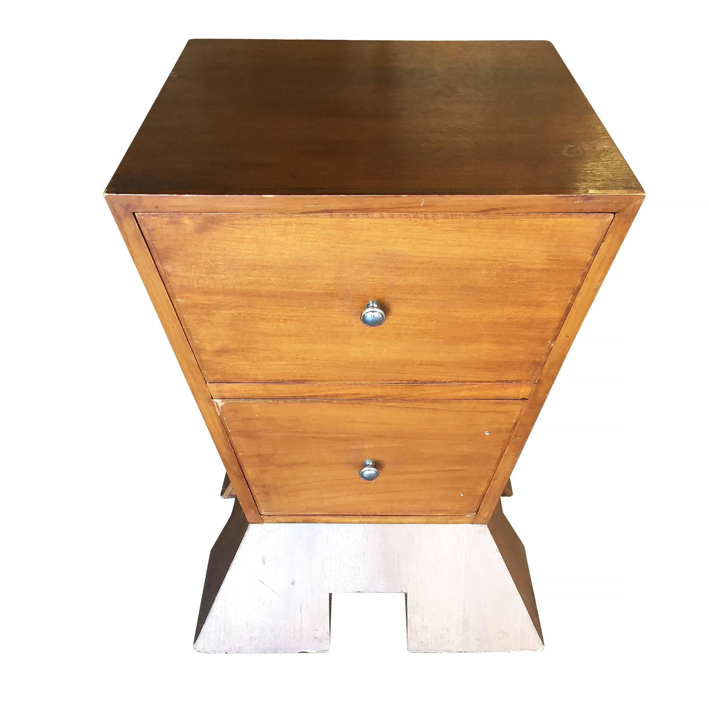 Unique modernist bedroom nightstand made of an inverted triangle on a triangular base with two drawers each with round pulls.