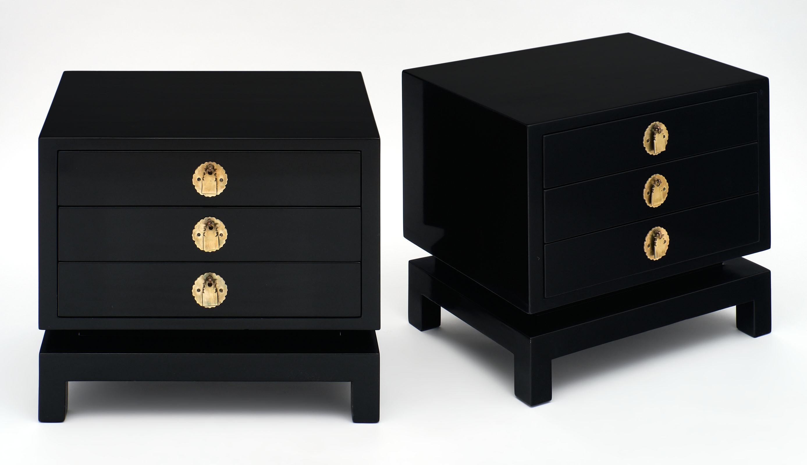 Mid-Century Modernist side tables in the manner of Pierre Cardin. We love the unique gilt bronze hardware and stylized legs. They have been ebonized and finished with a lustrous French polish. Each table has three drawers.