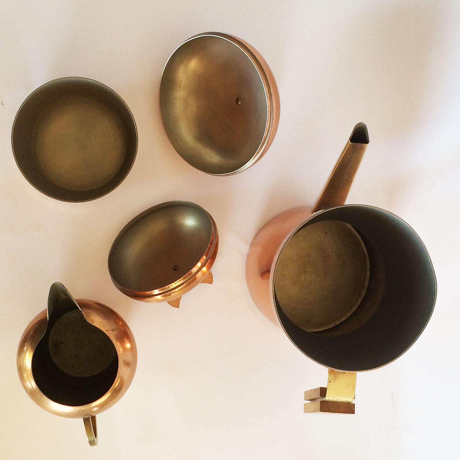 Modernist coffee set by Erich Kolbenheyer, in the style of Hagenauer. An amazing set in solid copper and Brass handles, and wooden (Teak?) moons as finger grips on lids.t All pieces are close to mint condition, with all the interiors in a satin